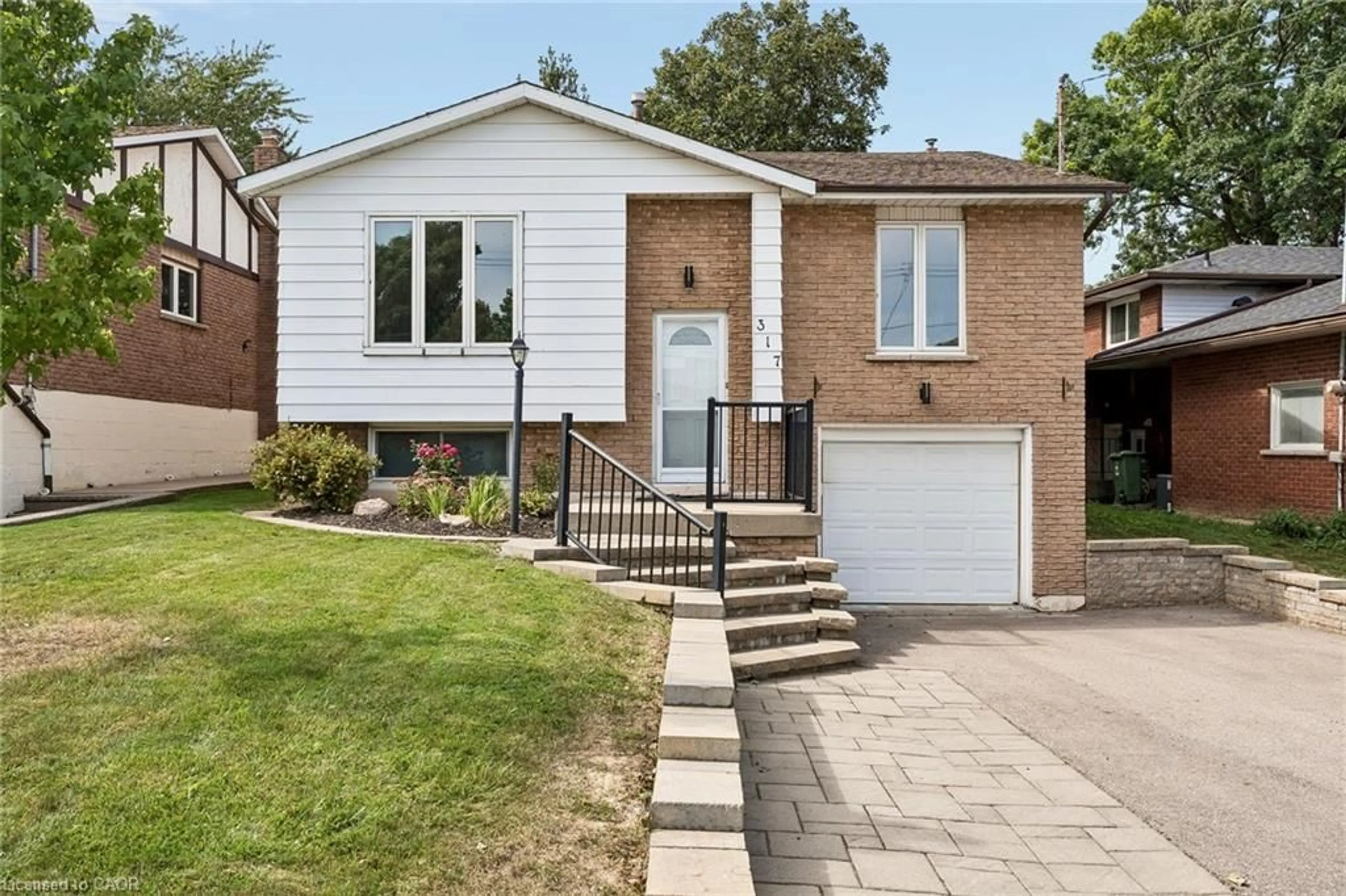 Home with brick exterior material, street for 317 Rexford Dr, Hamilton Ontario L8W 1W2