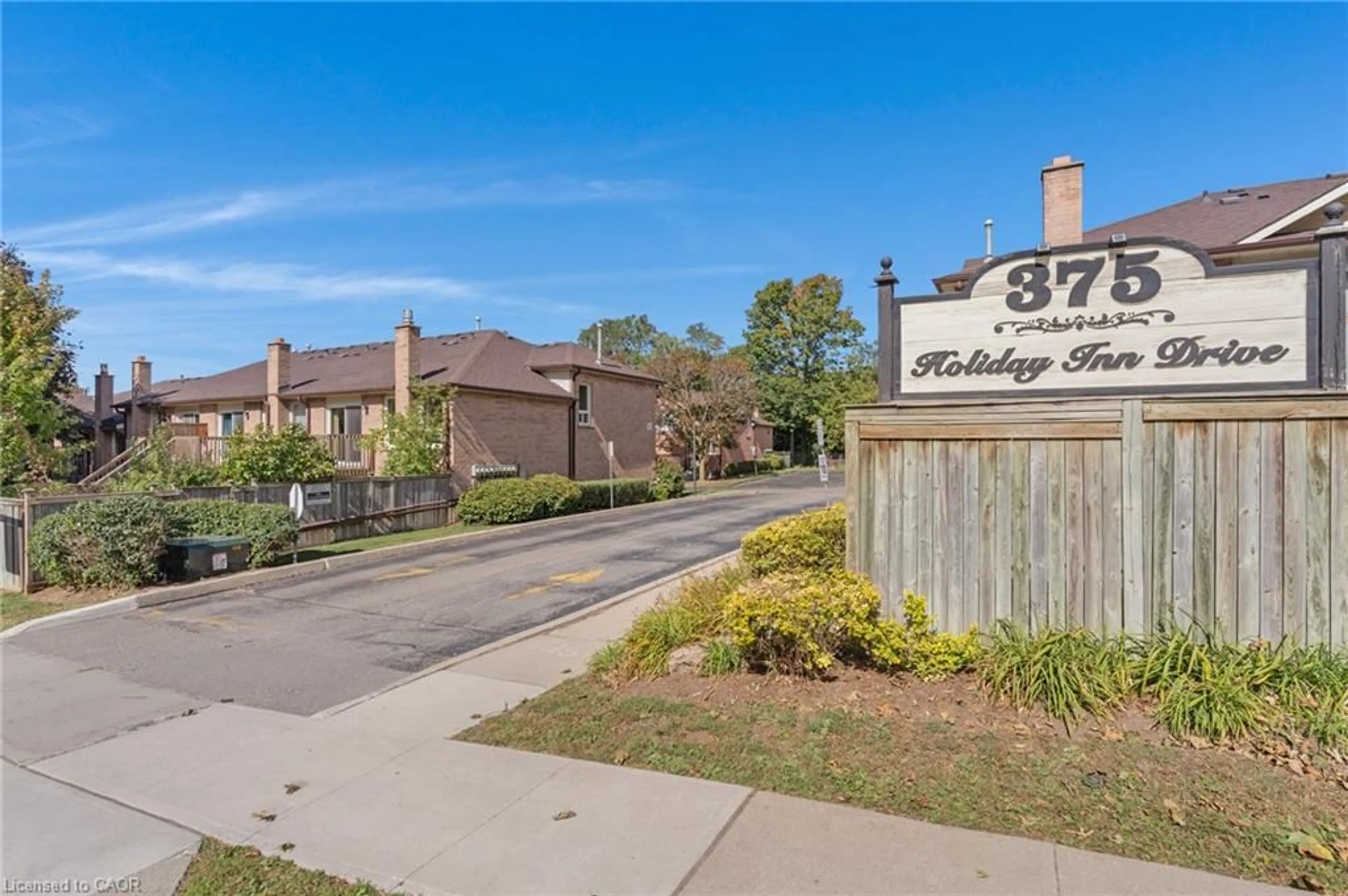 A pic from outside/outdoor area/front of a property/back of a property/a pic from drone, street for 375 Holiday Inn Dr #28, Cambridge Ontario N3C 3P6