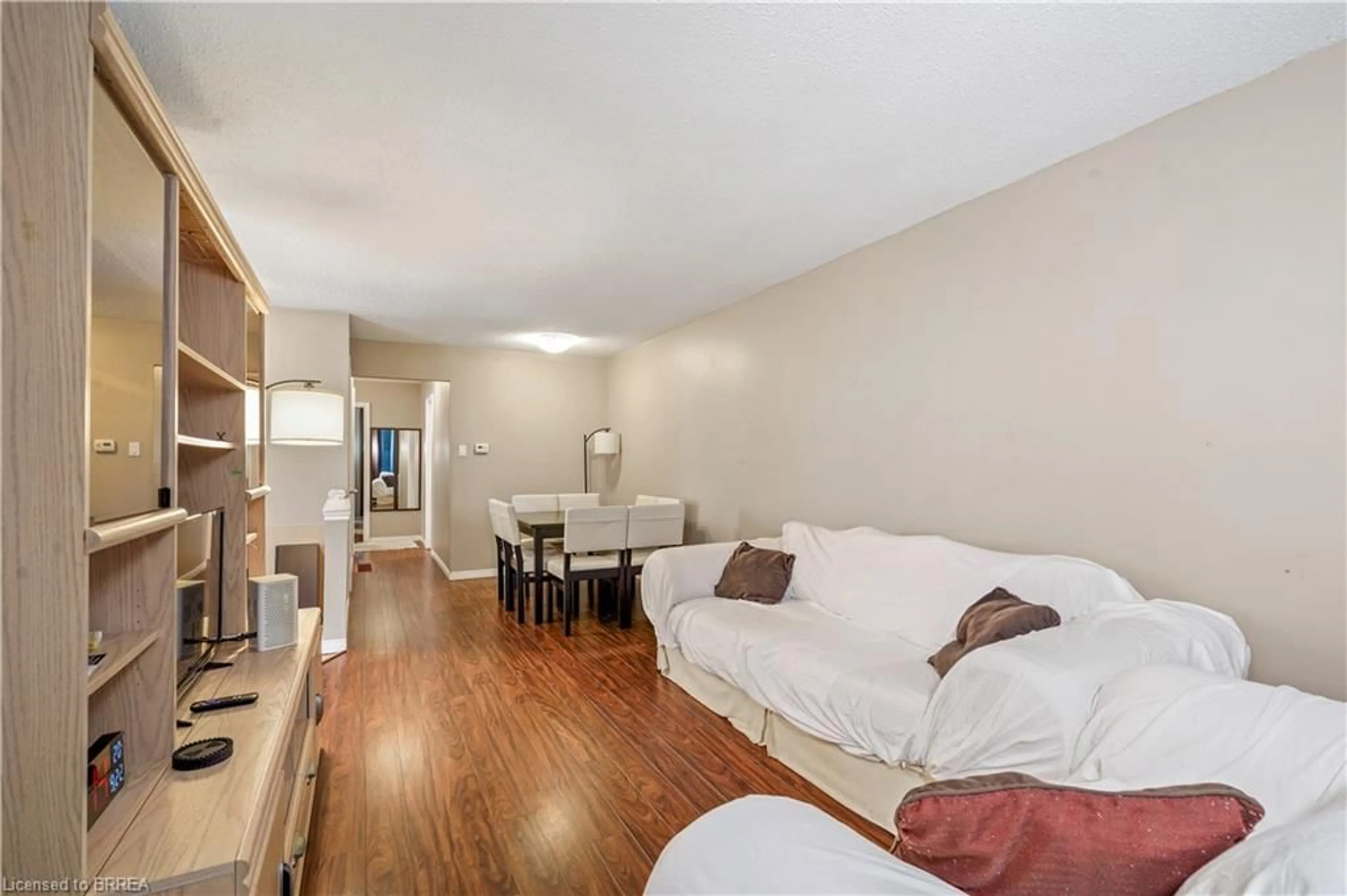 Living room with furniture, wood/laminate floor for 23 Palomino Dr, Brantford Ontario N3P 1J6