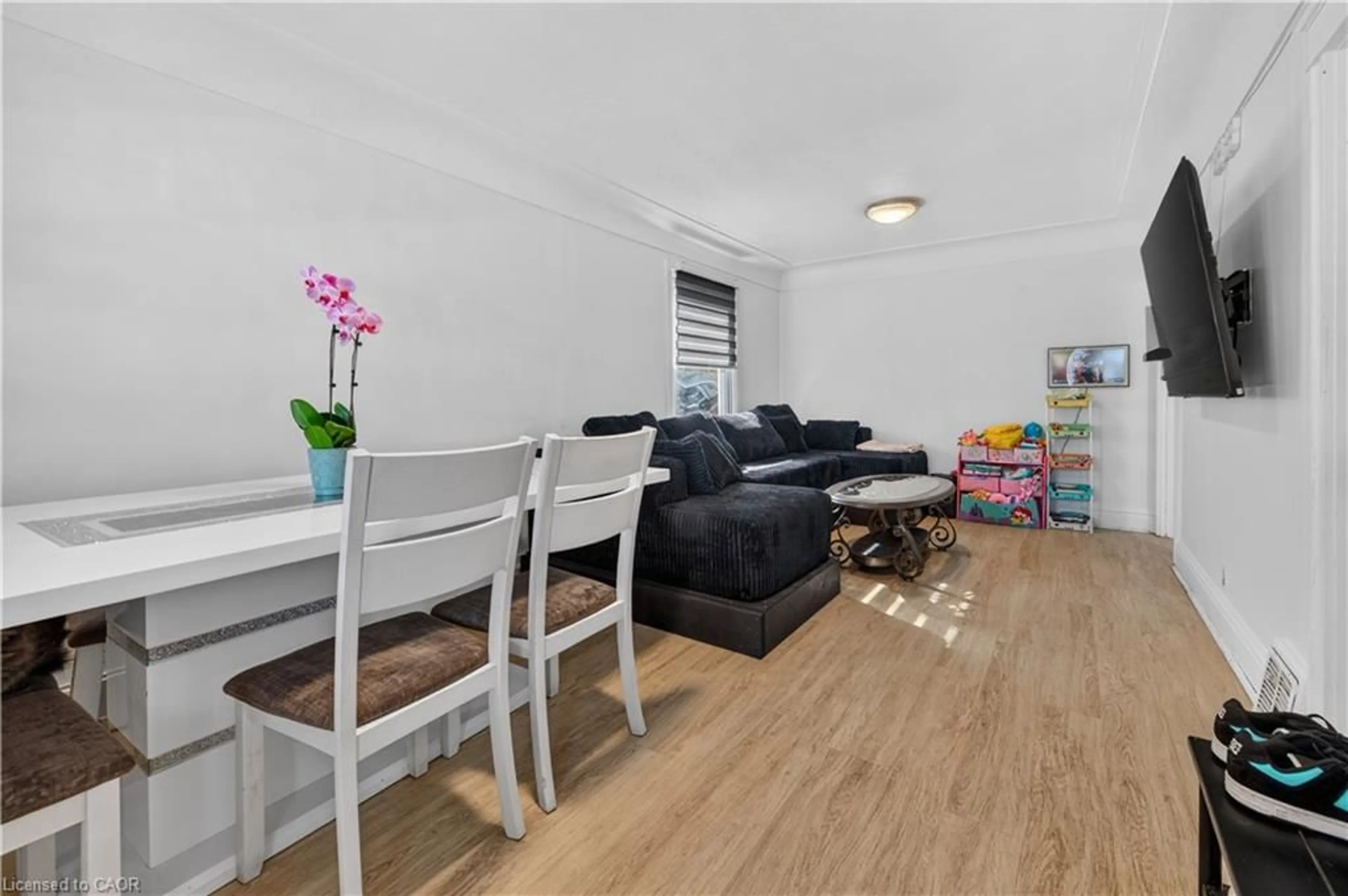 Living room with furniture, wood/laminate floor for 21 Cameron Ave, Hamilton Ontario L8H 4Y9