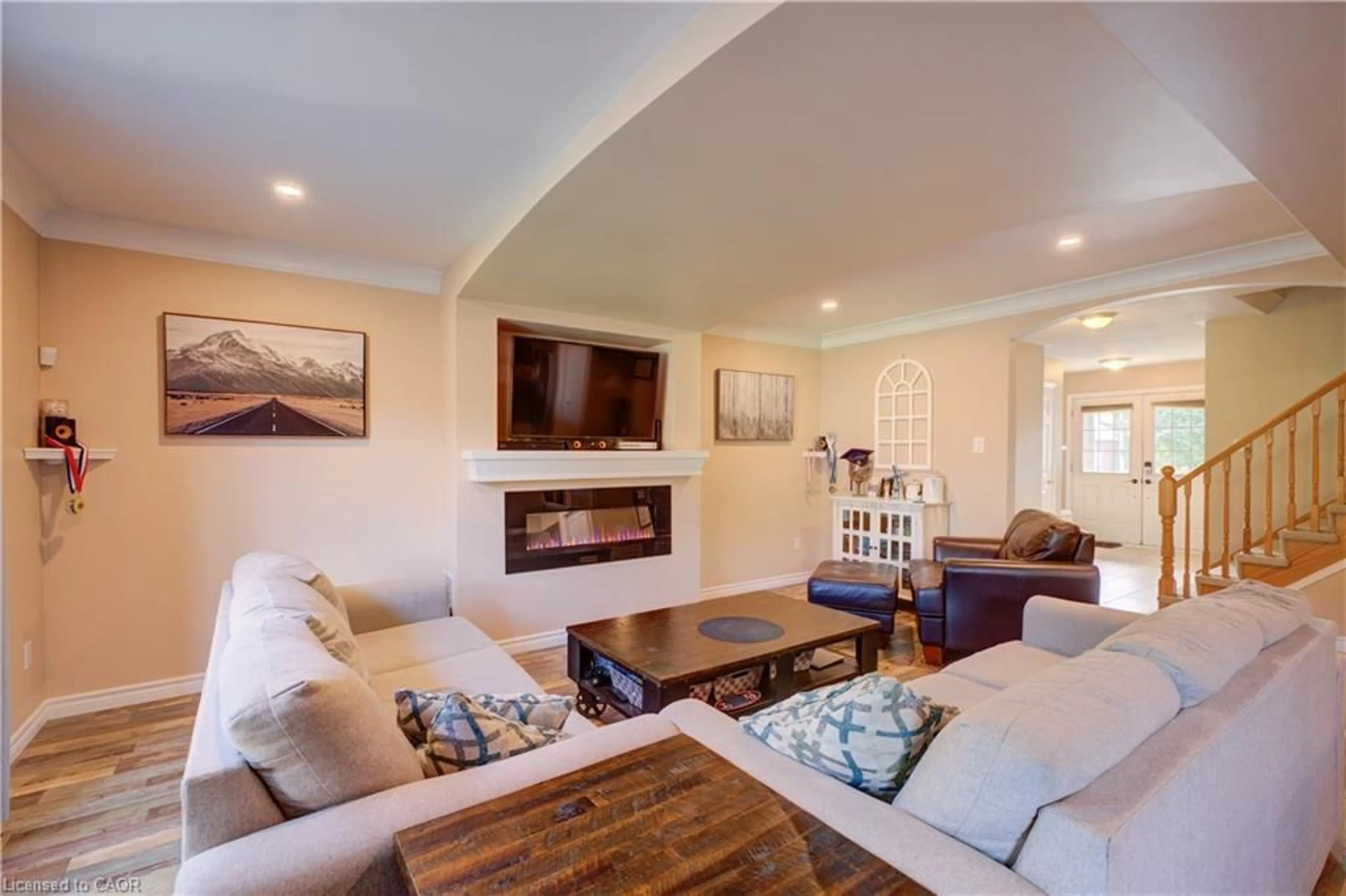 Living room with furniture, wood/laminate floor for 3 Fuller Crt, Brantford Ontario N3S 0A6
