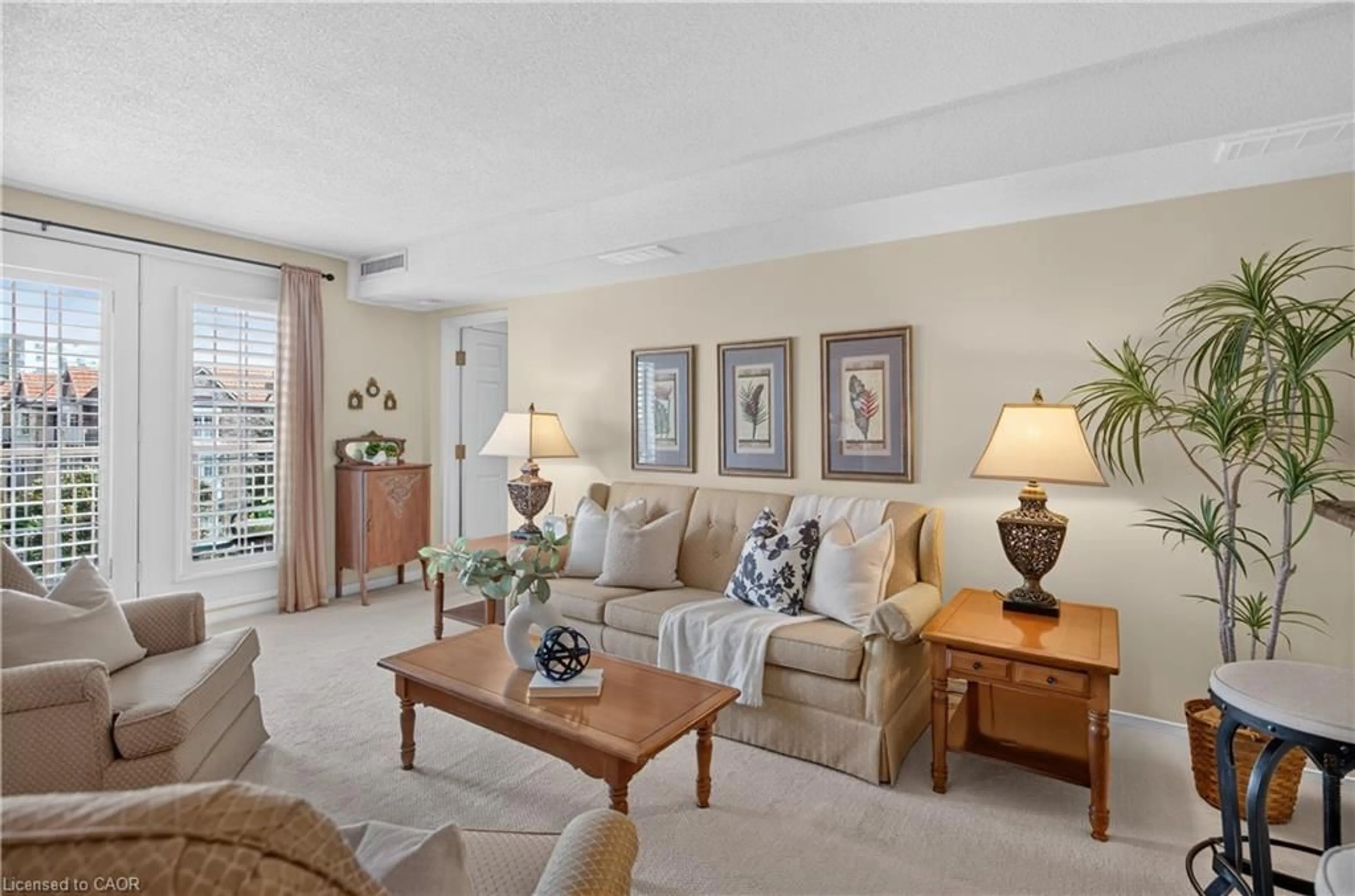 Living room with furniture, carpet floor for 216 Plains Rd #B404, Burlington Ontario L7T 4K8