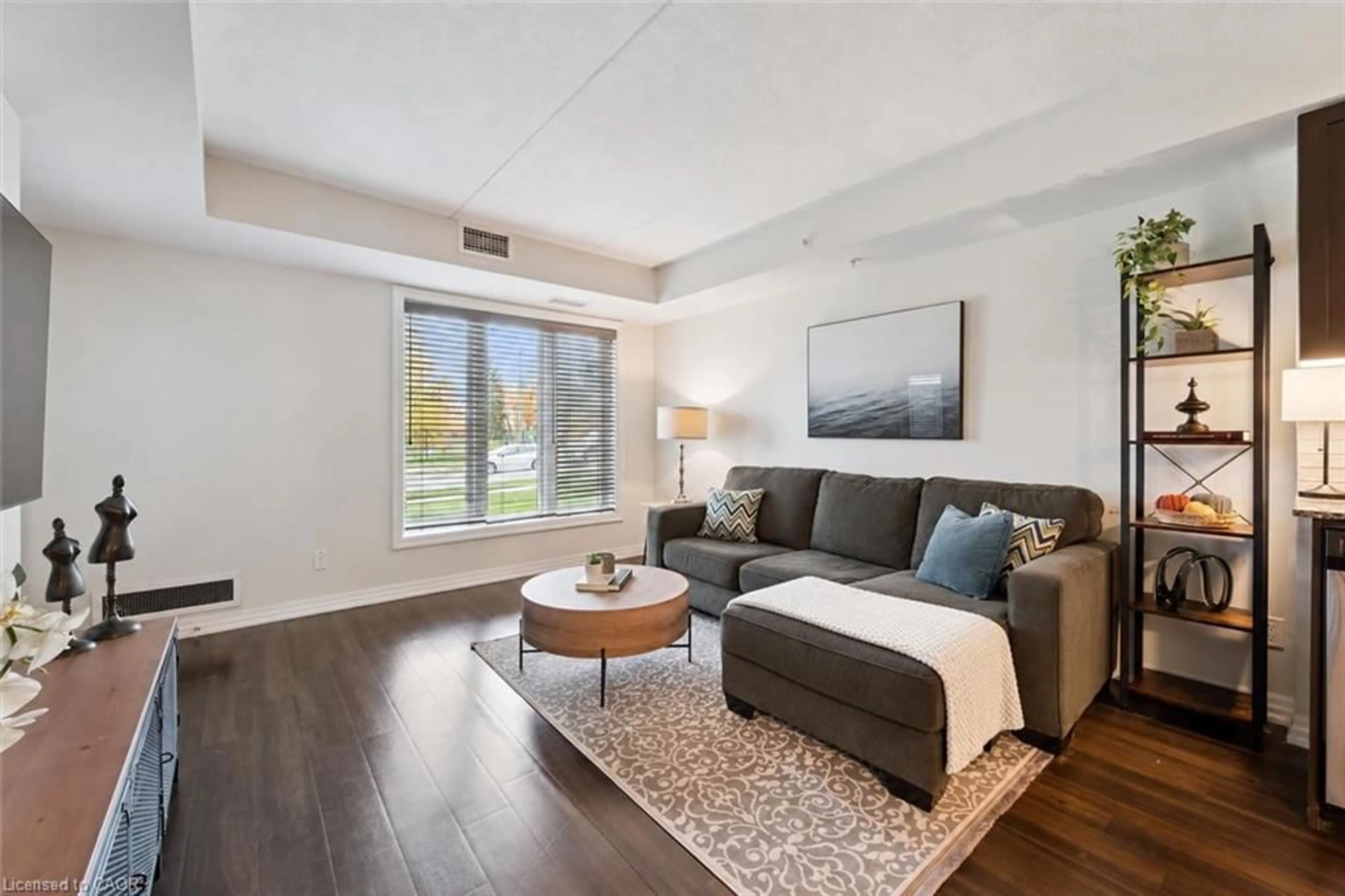 Living room with furniture, wood/laminate floor for 104 Summit Ridge Dr #106, Guelph Ontario N1E 0R5