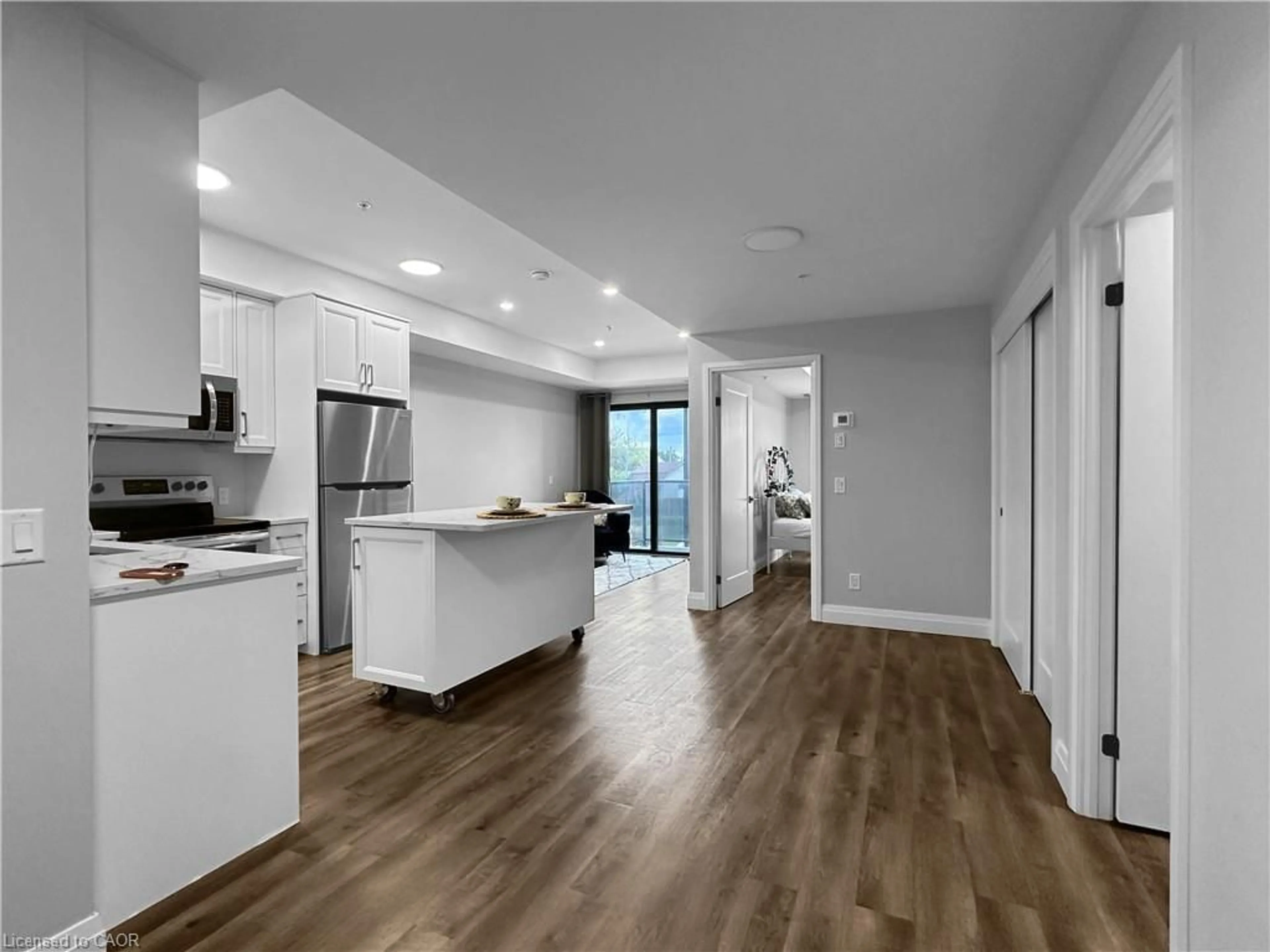 Open concept kitchen, wood/laminate floor for 64 Main St #210, Hagersville Ontario N0A 1H0