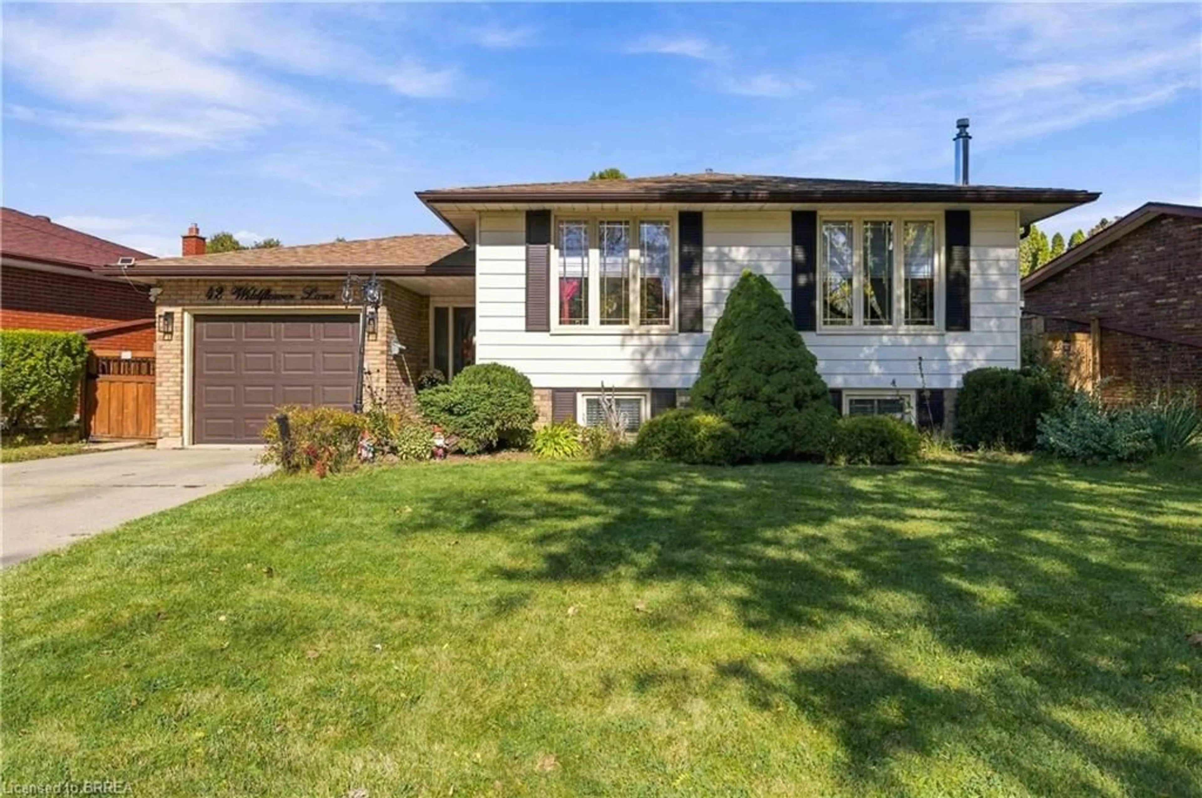 Home with vinyl exterior material, street for 42 Wildflower Lane, Brantford Ontario N3R 7H6