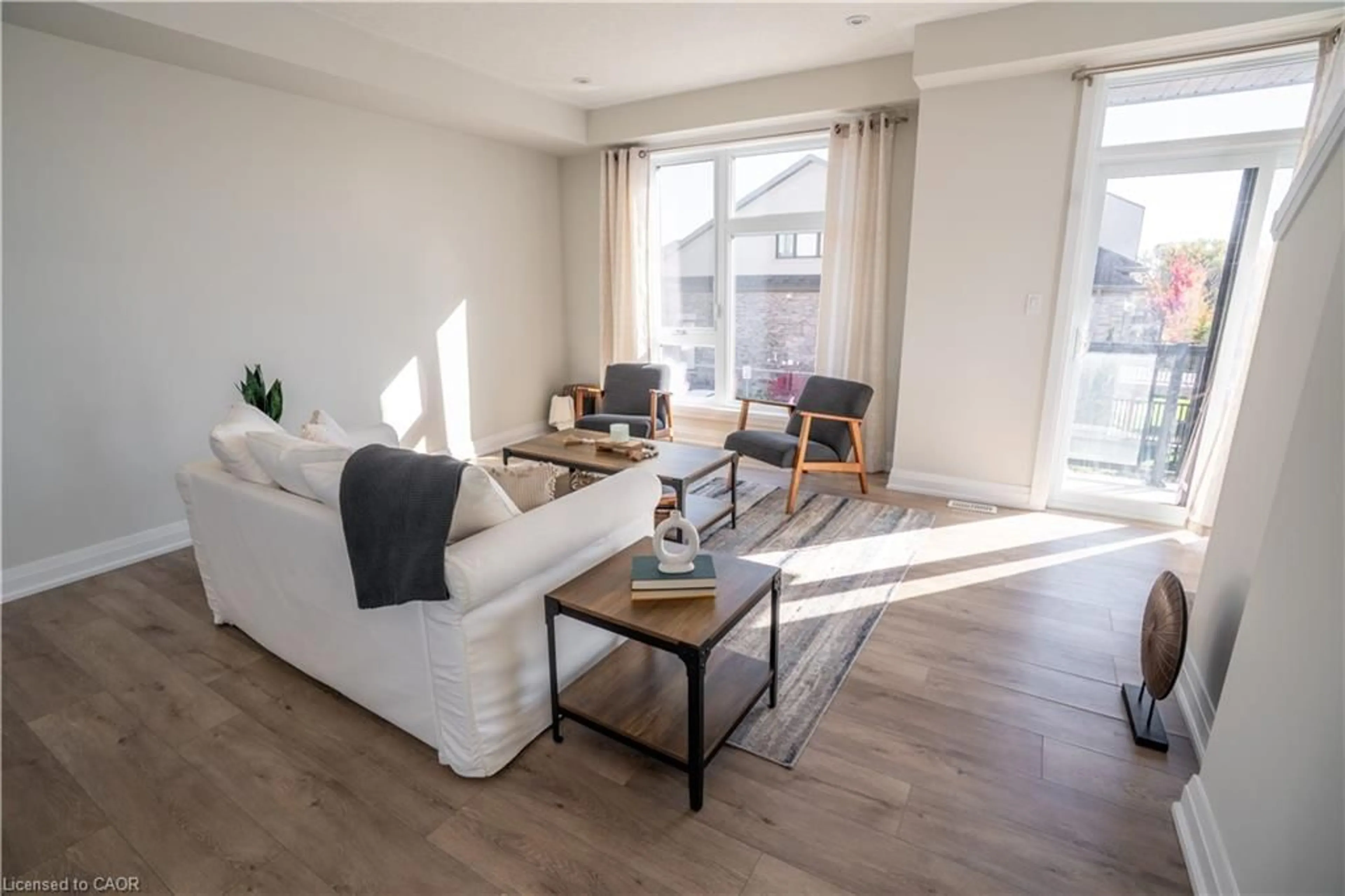 Living room with furniture, wood/laminate floor for 271 Grey Silo Rd #52, Waterloo Ontario N2K 0E9