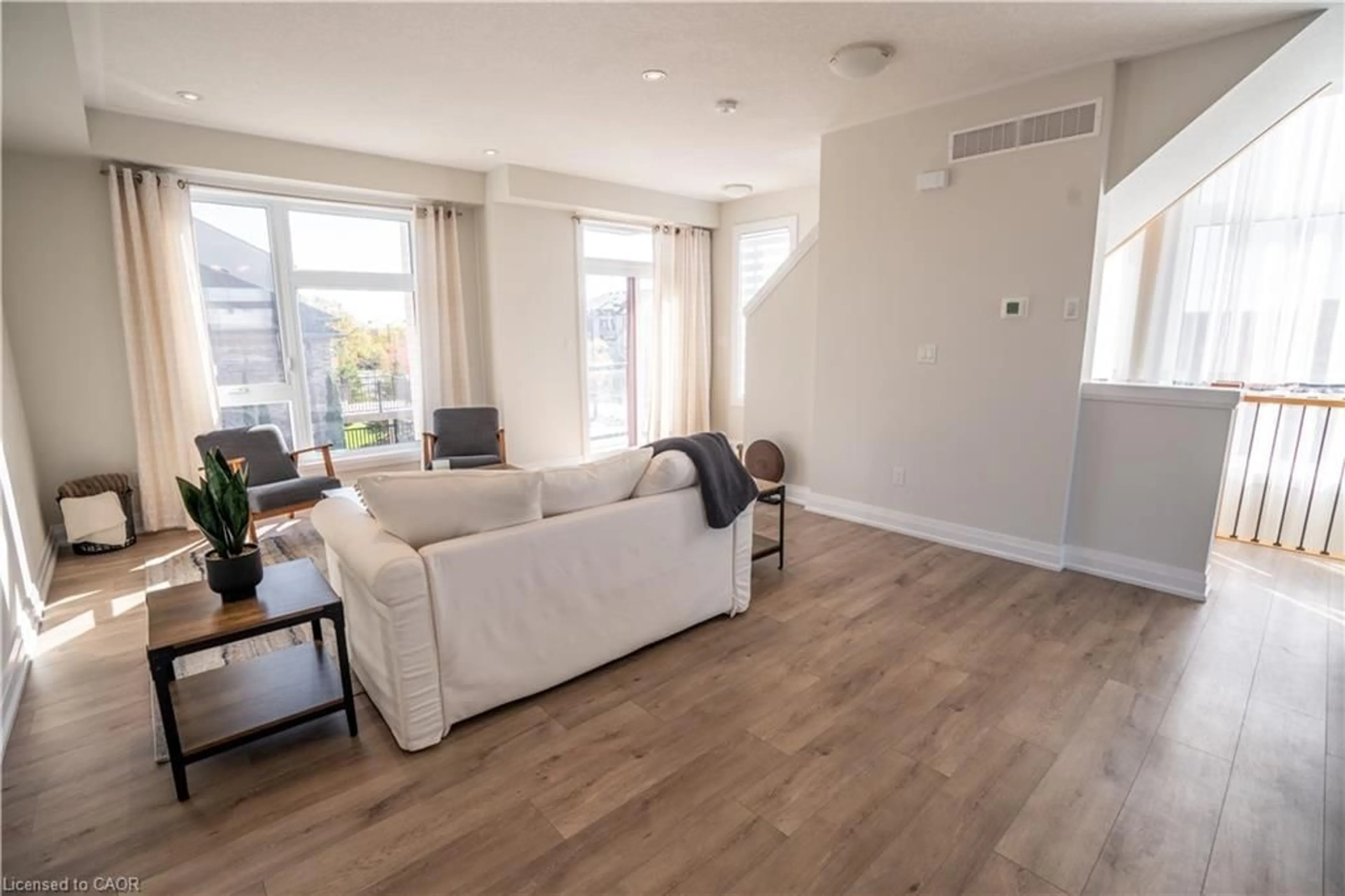 Living room with furniture, wood/laminate floor for 271 Grey Silo Rd #52, Waterloo Ontario N2K 0E9