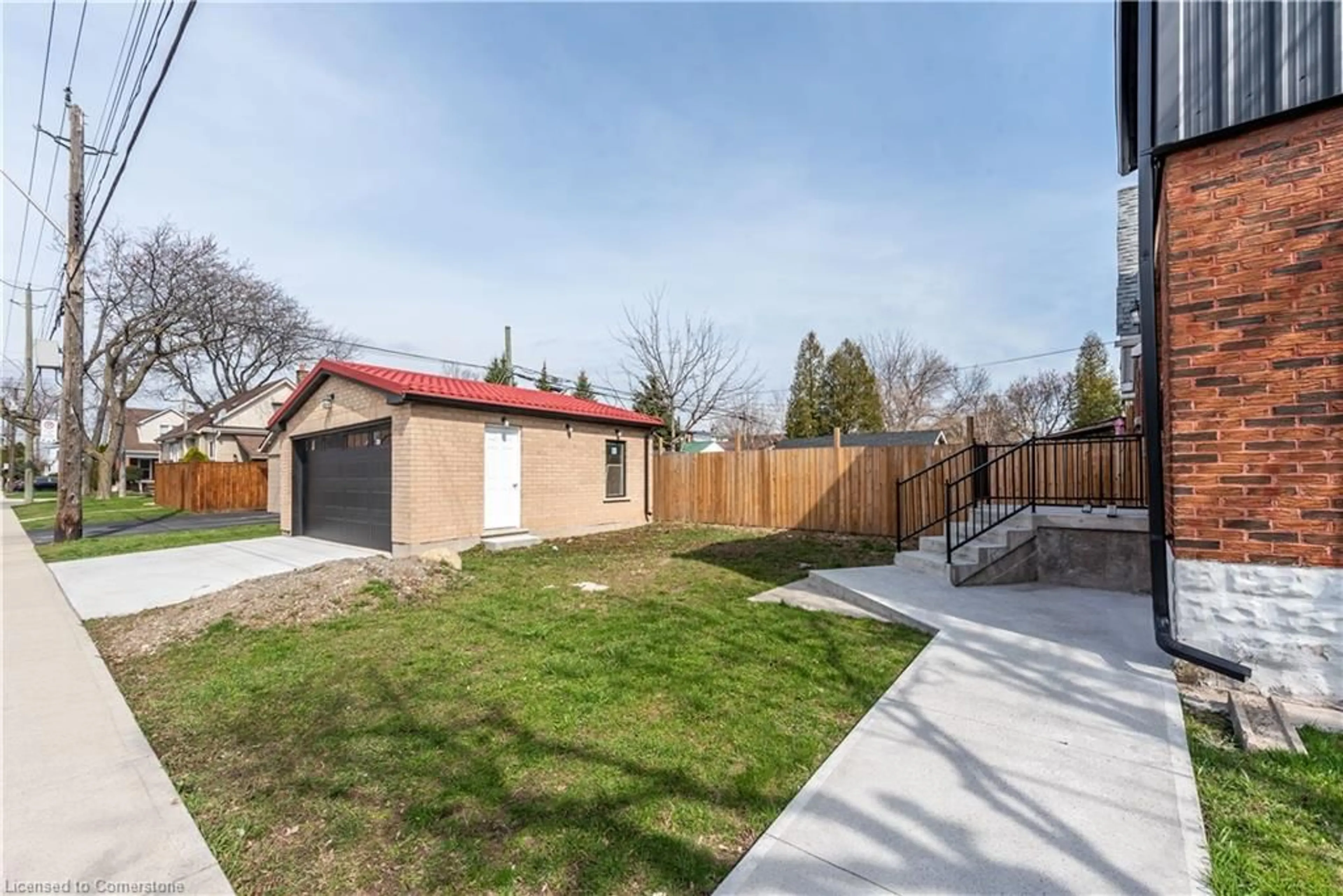 Frontside or backside of a home, the fenced backyard for 49 Cameron Ave, Hamilton Ontario L8H 4Z1