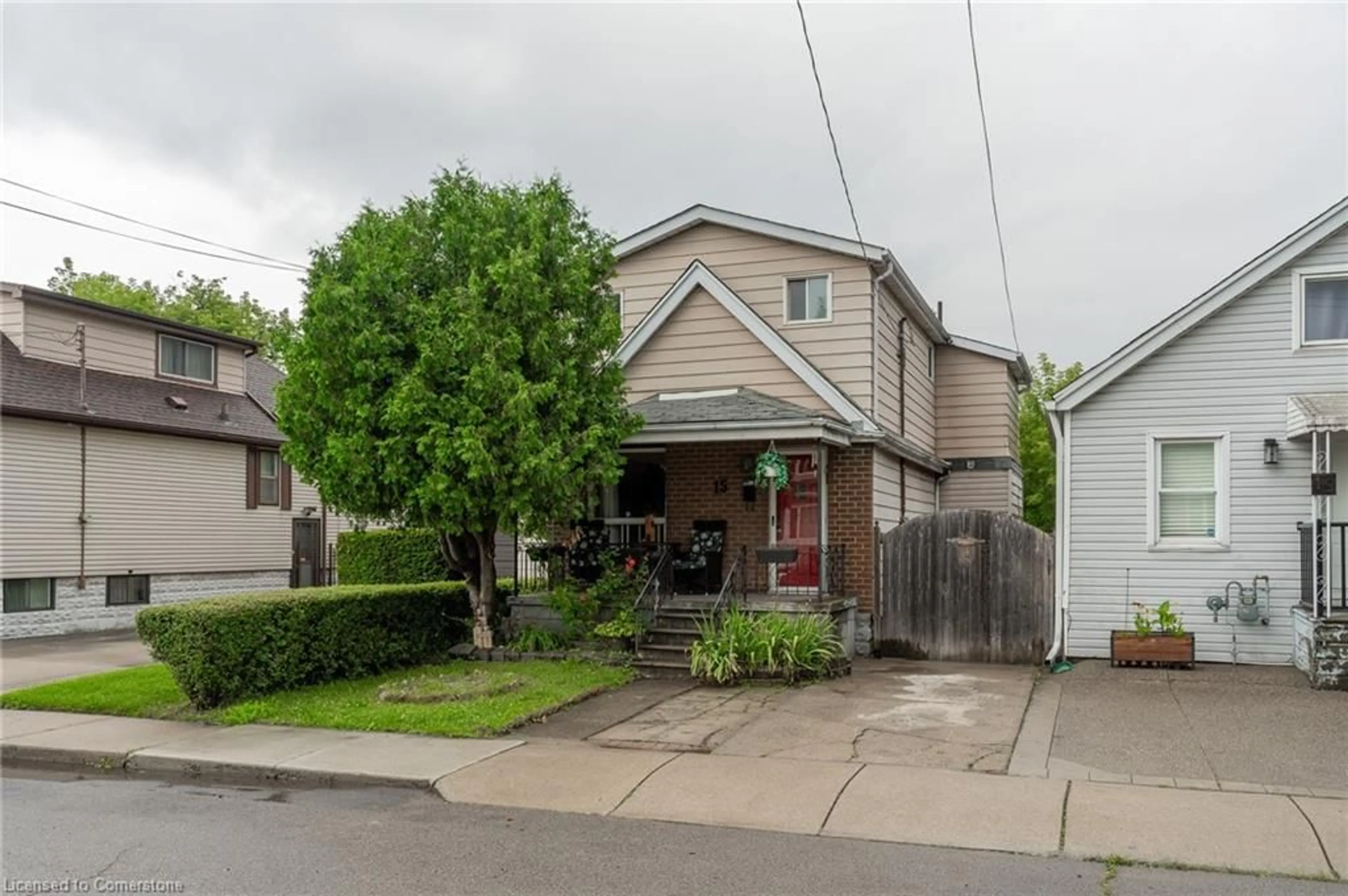 Frontside or backside of a home, the fenced backyard for 15 Agnes St, Hamilton Ontario L8H 4H1