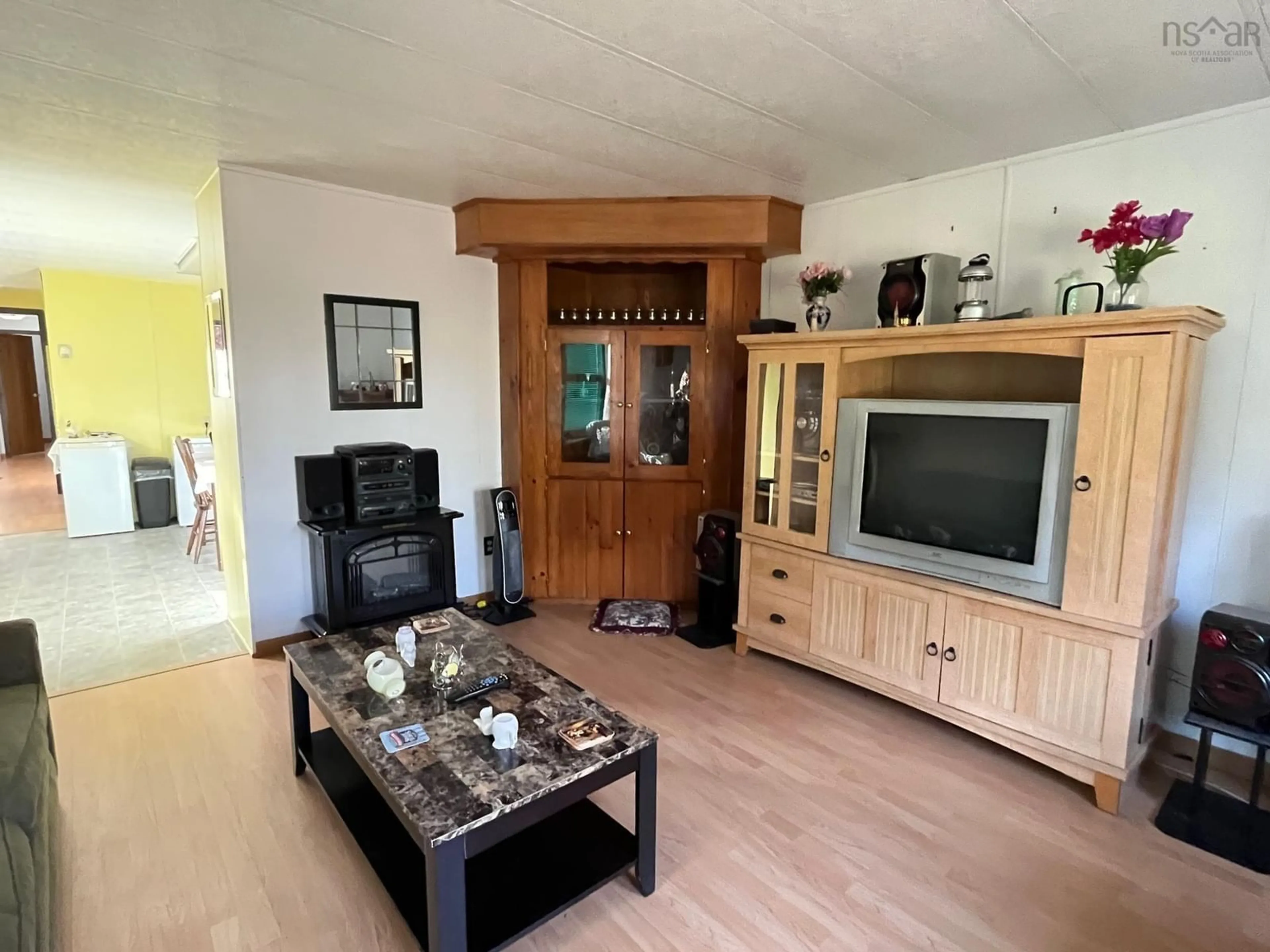 Living room with furniture, wood/laminate floor for 83 Whycocomagh Mtn Rd, Whycocomagh Nova Scotia B0E 3M0