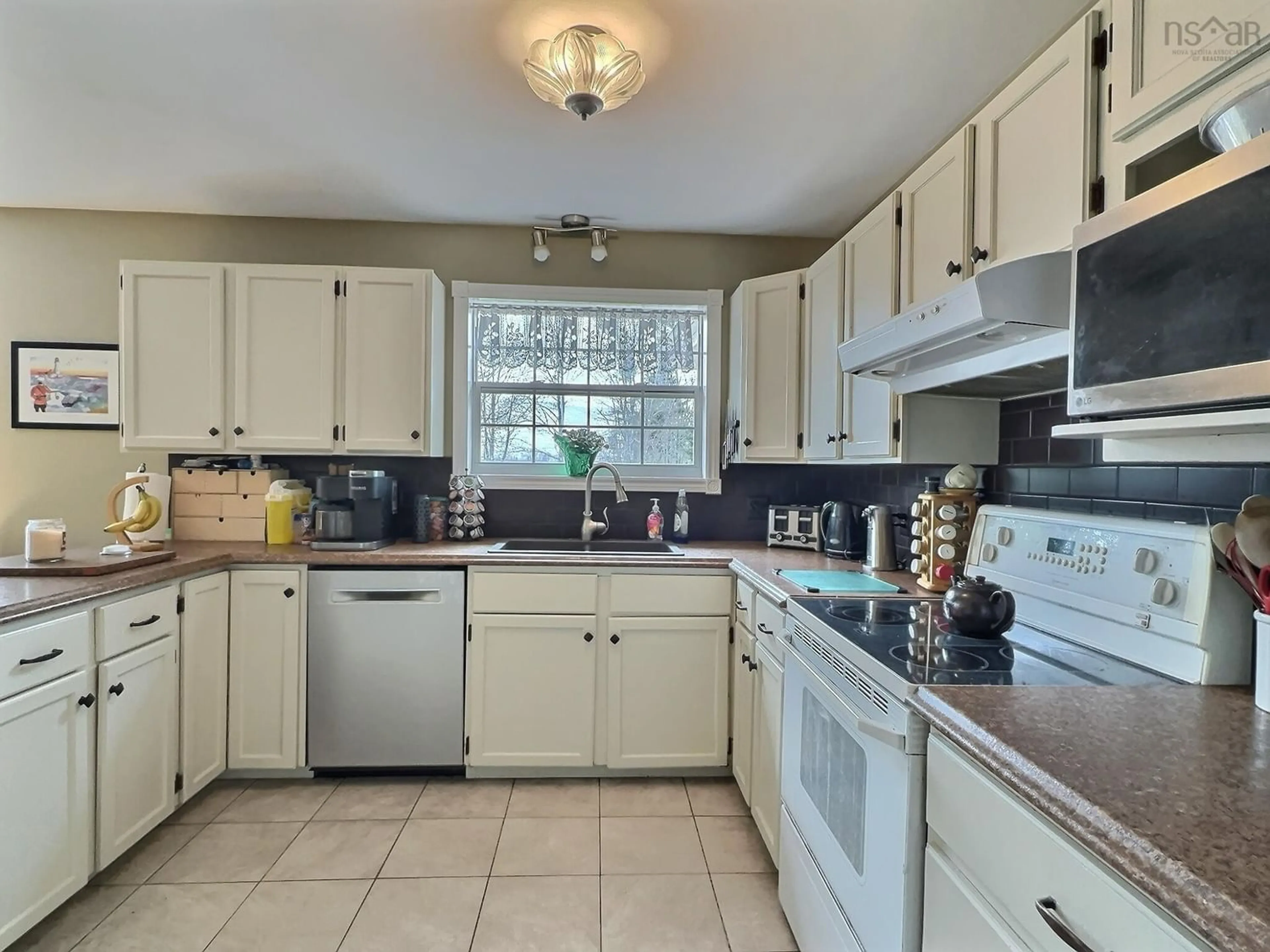 Standard kitchen, wood floors, cottage for 180 Lake Shore Dr, Great Village Nova Scotia B0M 1L0