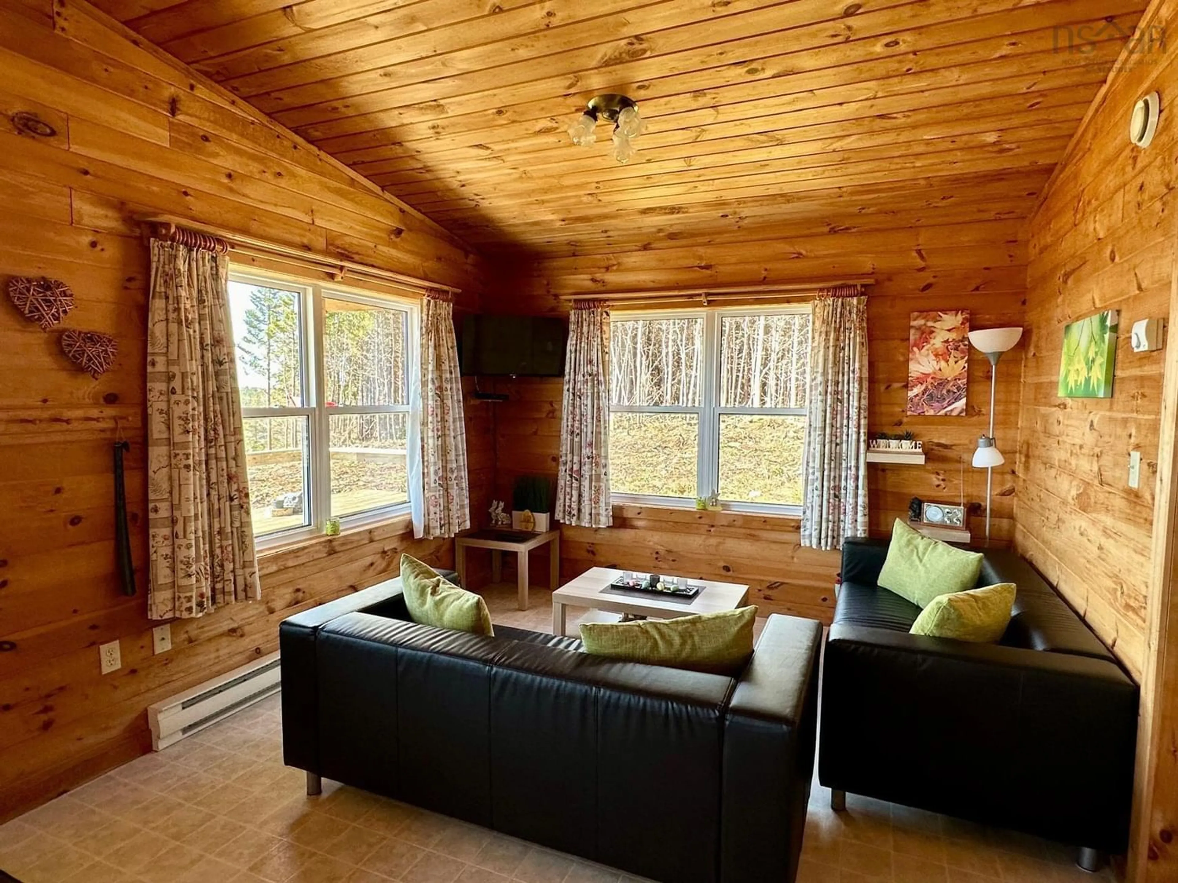 Living room with furniture, wood/laminate floor for 34 Eagle Valley Road, Upper Fox Island Nova Scotia B0H 1H0