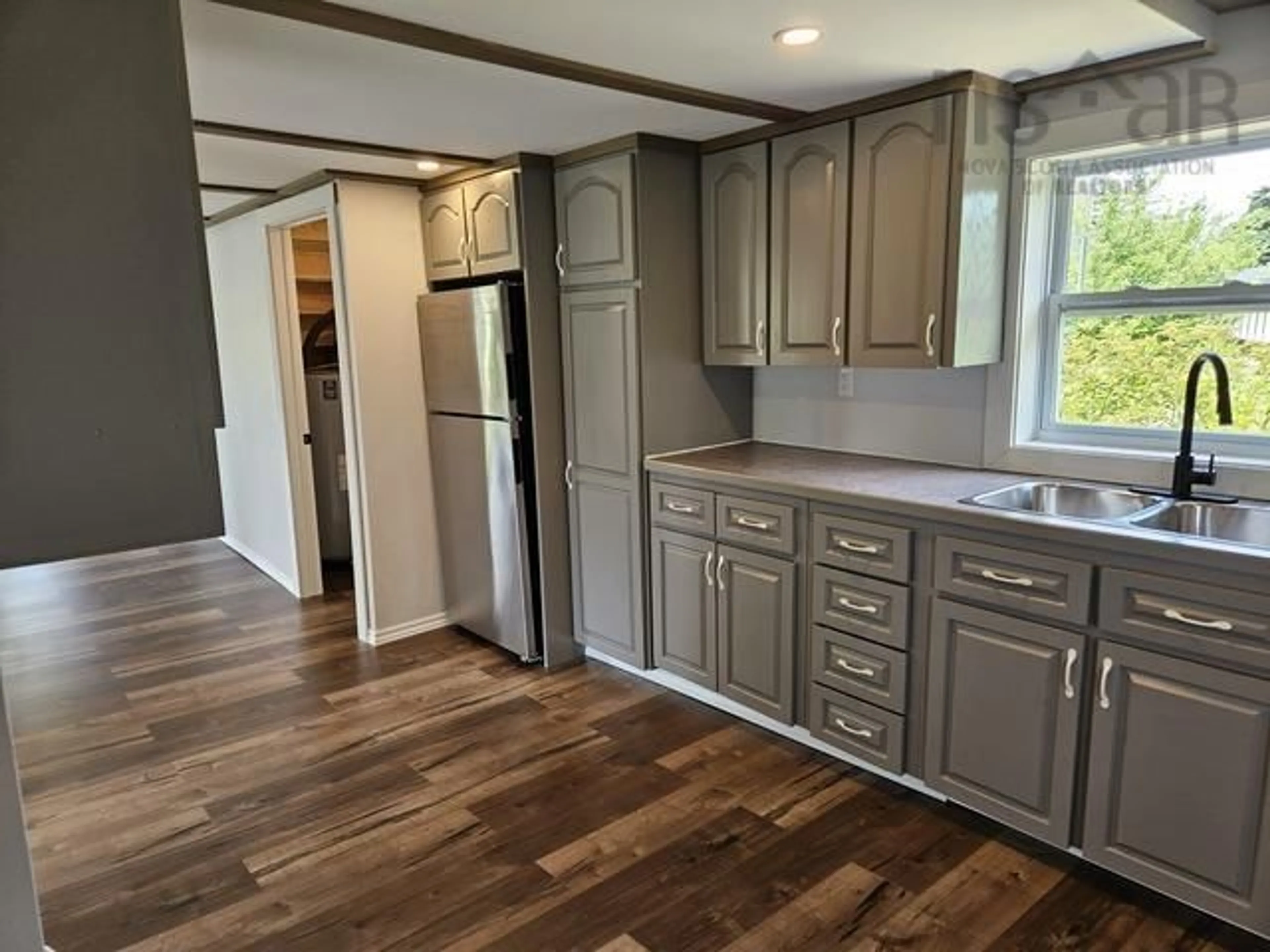 Open concept kitchen, wood/laminate floor for 67 Bear Point Rd, Bear Point Nova Scotia B0W 3B0