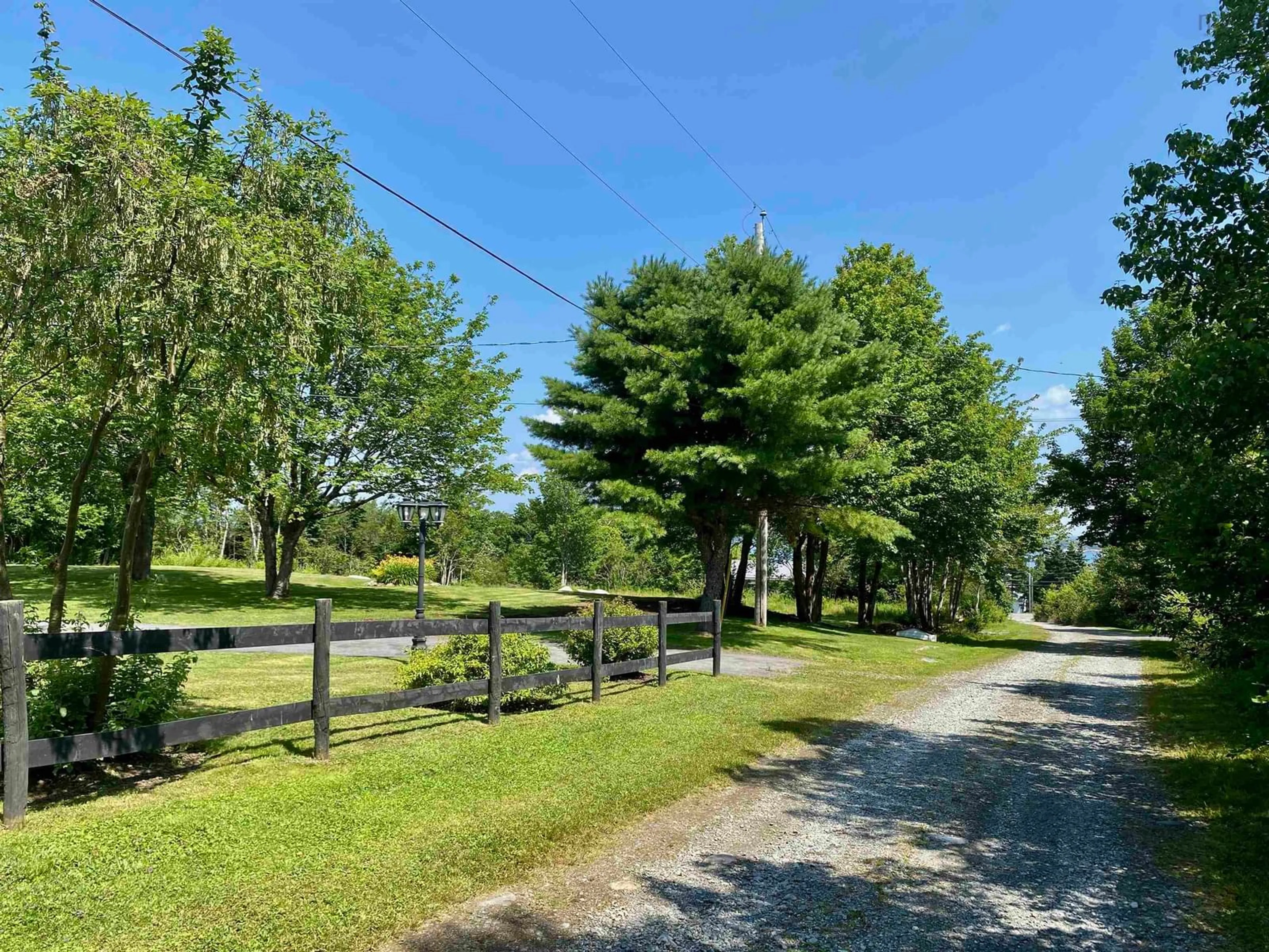 A pic from exterior of the house or condo, the fenced backyard for 32 Maple Dr, Mersey Point Nova Scotia B0T 1K0