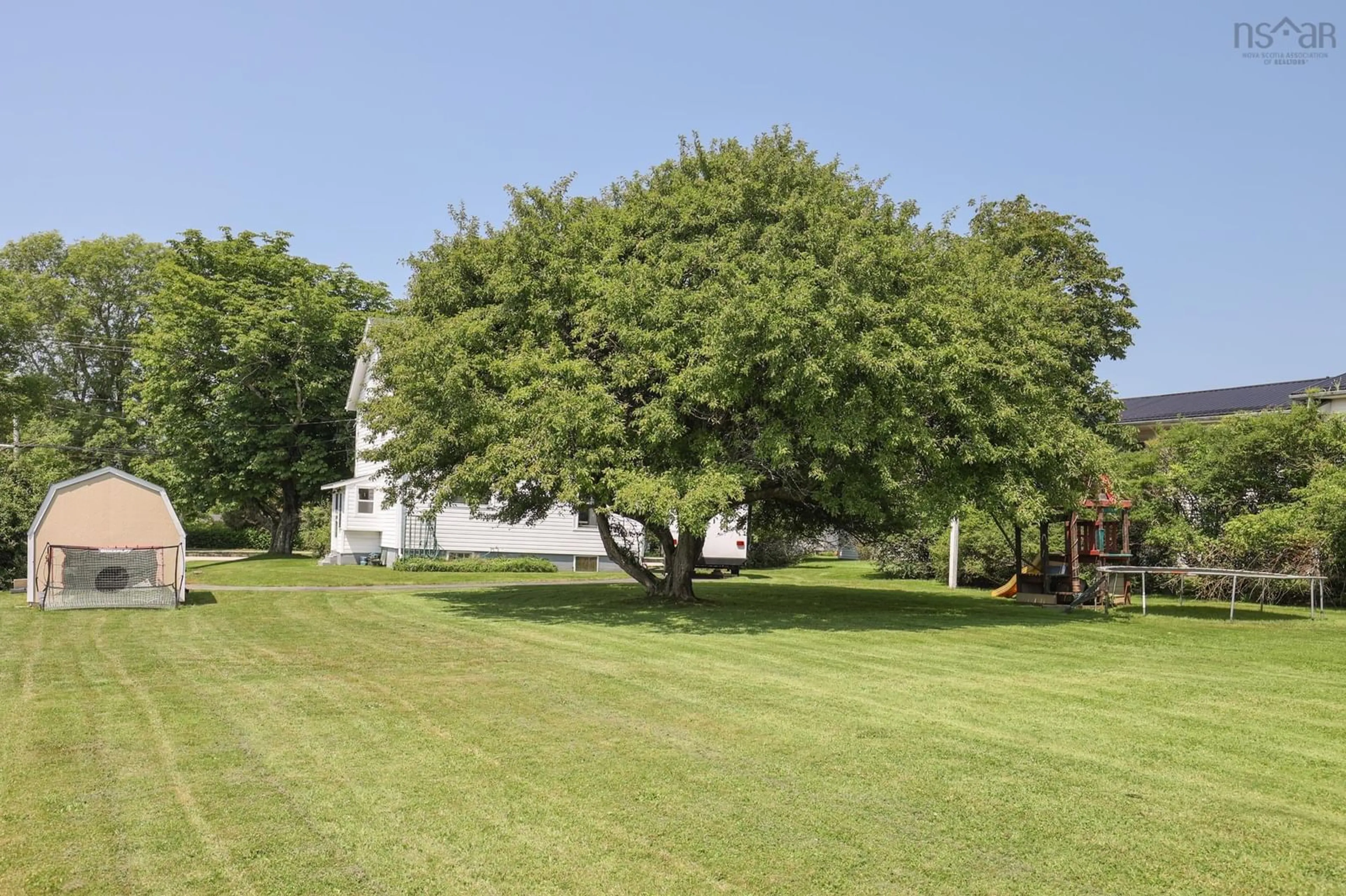 A pic from exterior of the house or condo, the fenced backyard for 323 Pleasant St, Yarmouth Nova Scotia B5A 2K9