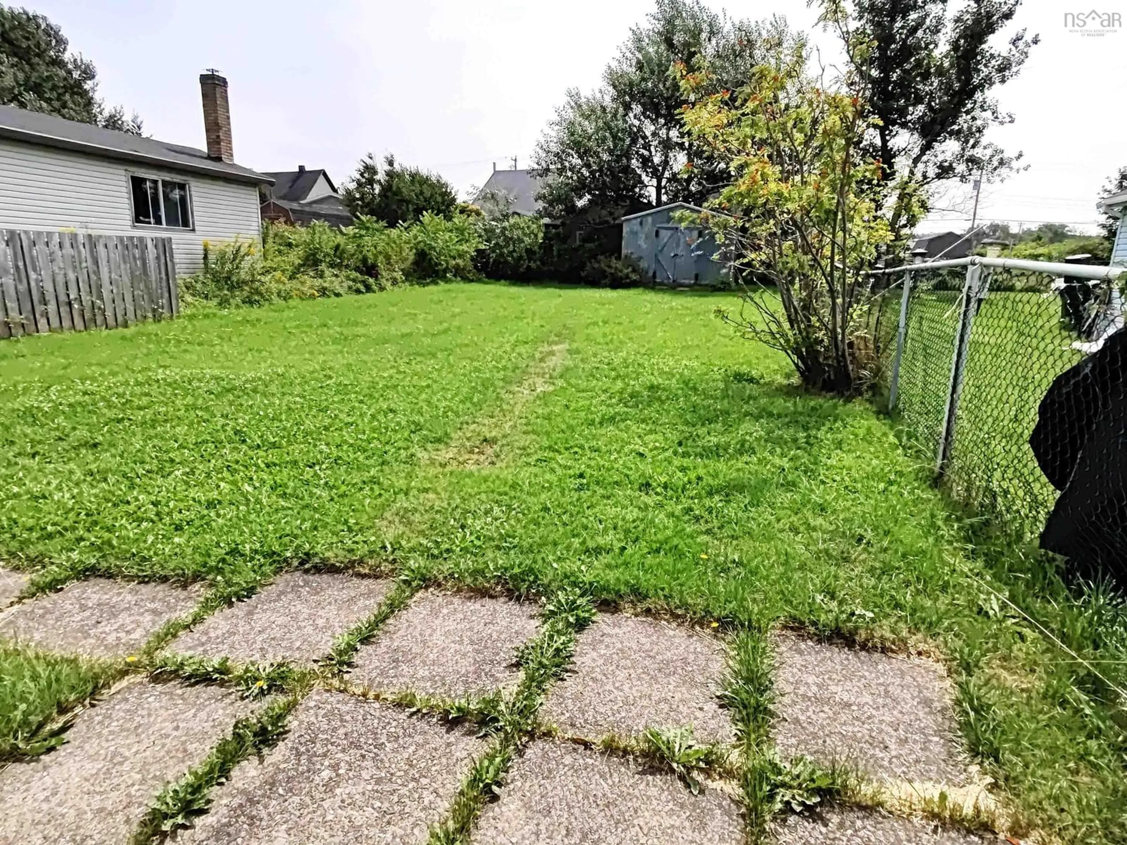 Frontside or backside of a home, the fenced backyard for 49 Church St, Dominion Nova Scotia B1G 1A8