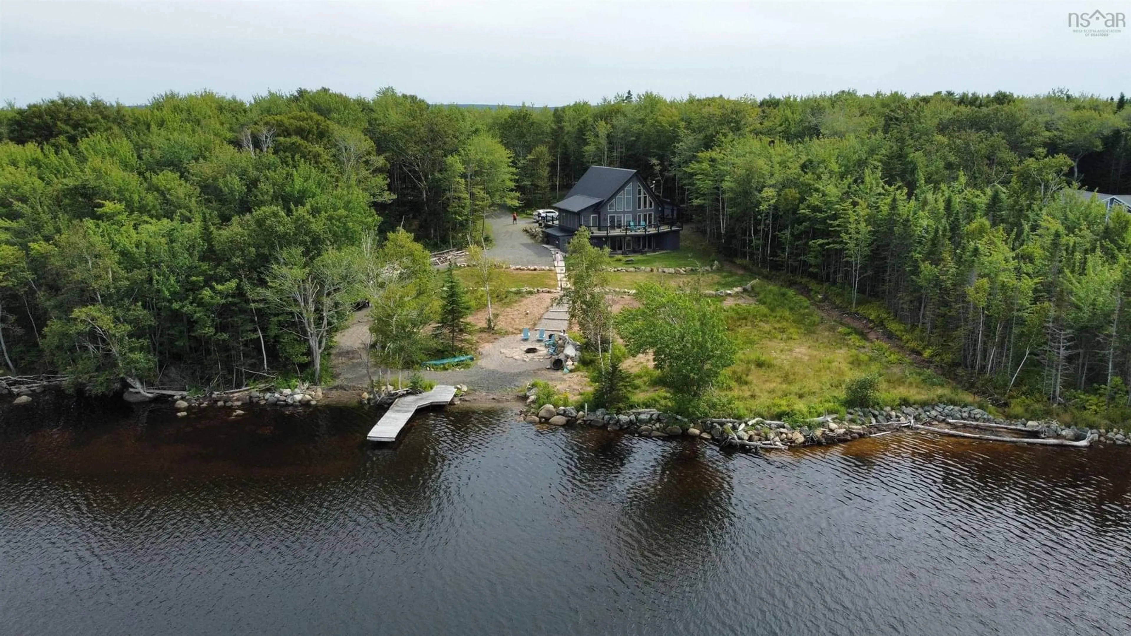 A pic from outside/outdoor area/front of a property/back of a property/a pic from drone, water/lake/river/ocean view for 152 Mersey Rd, Inlet Baddeck Nova Scotia B0E 1B0