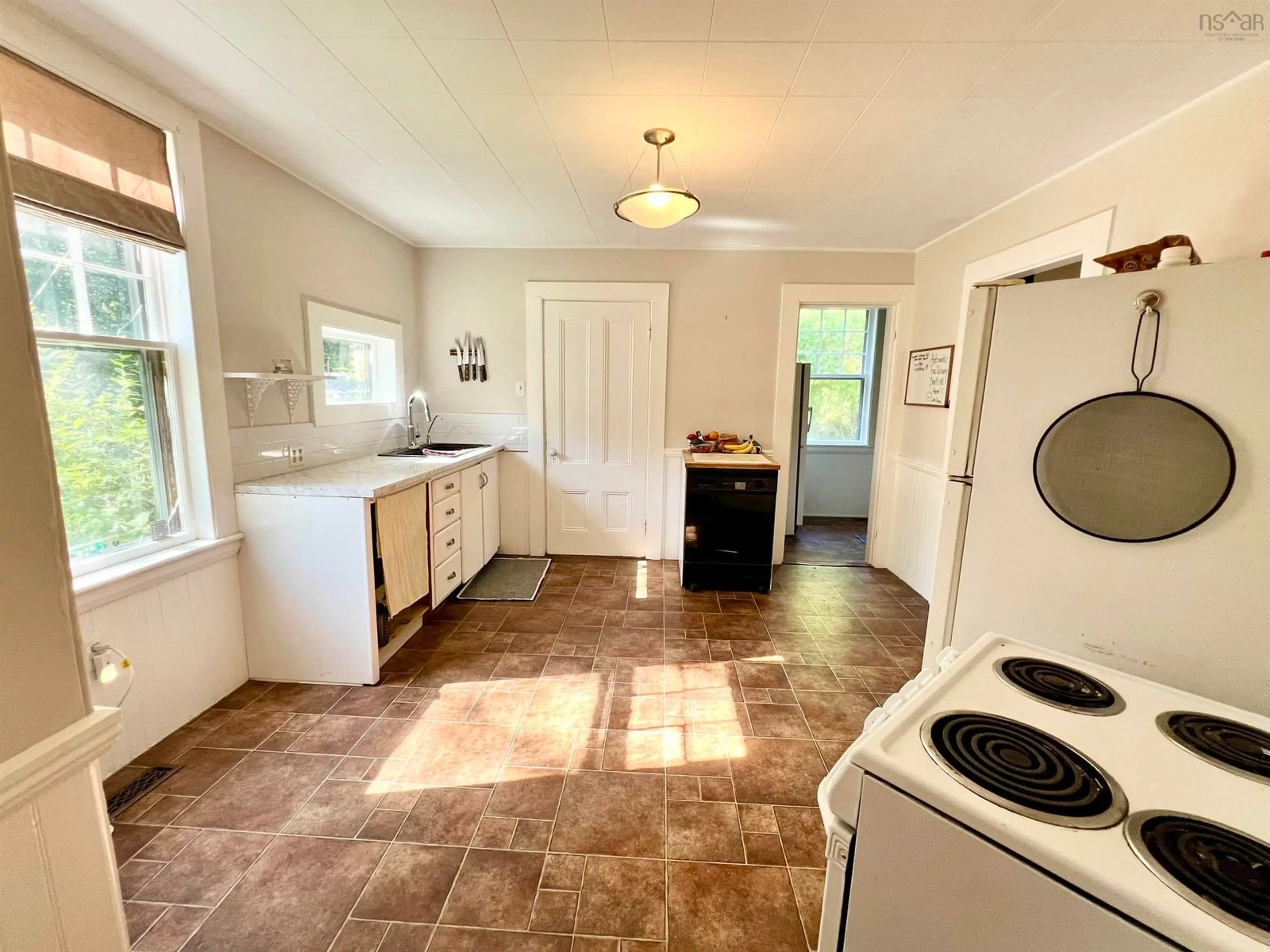 Kitchen with laundary machines, wood floors for 12 Falls Lane, Shelburne Nova Scotia B0T 1W0