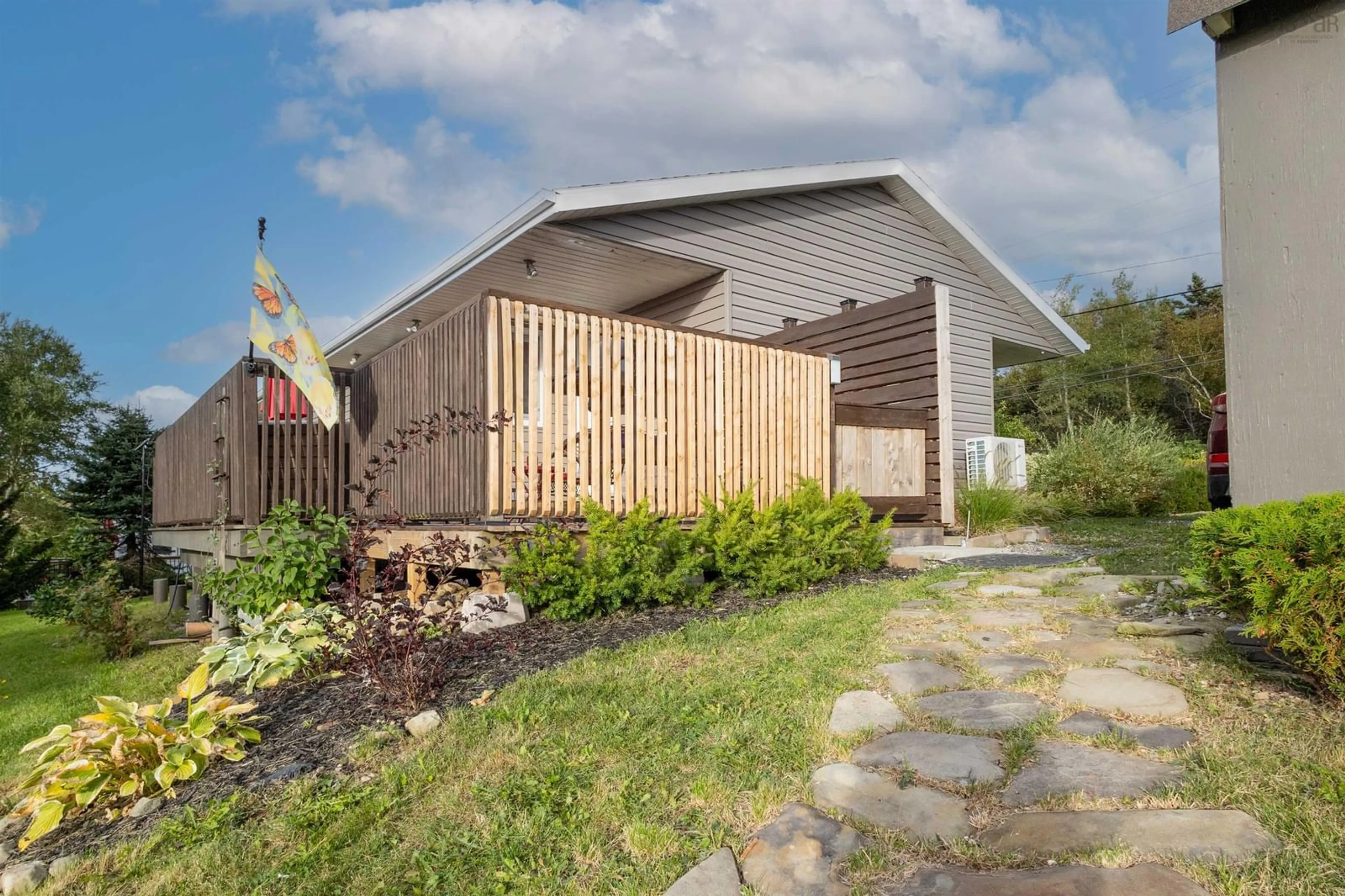 Frontside or backside of a home, the fenced backyard for 2295 Highway 28, South Bar Nova Scotia B1N 3H8