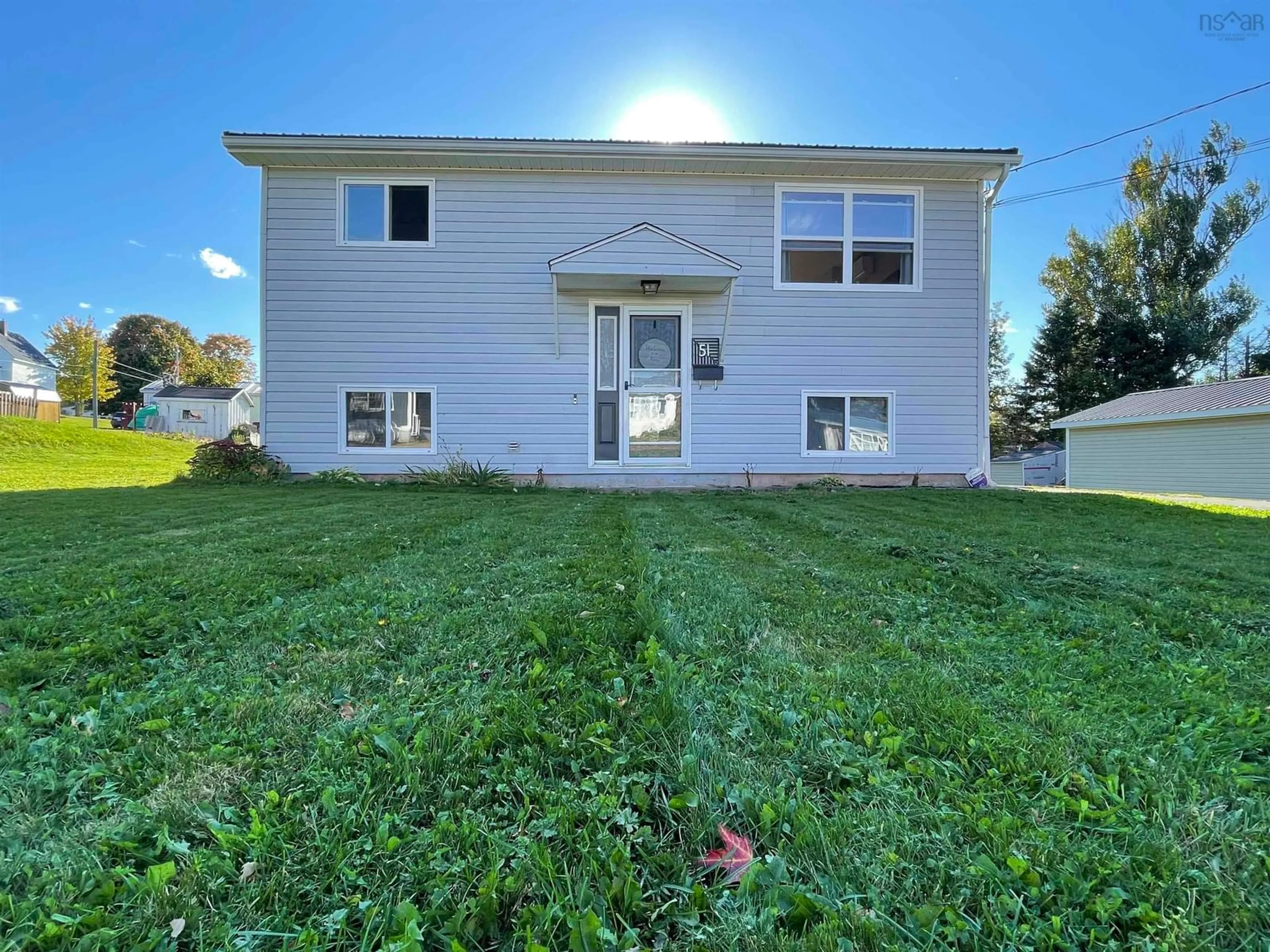 Frontside or backside of a home, the fenced backyard for 51 Charles St, Amherst Nova Scotia B4H 4T6