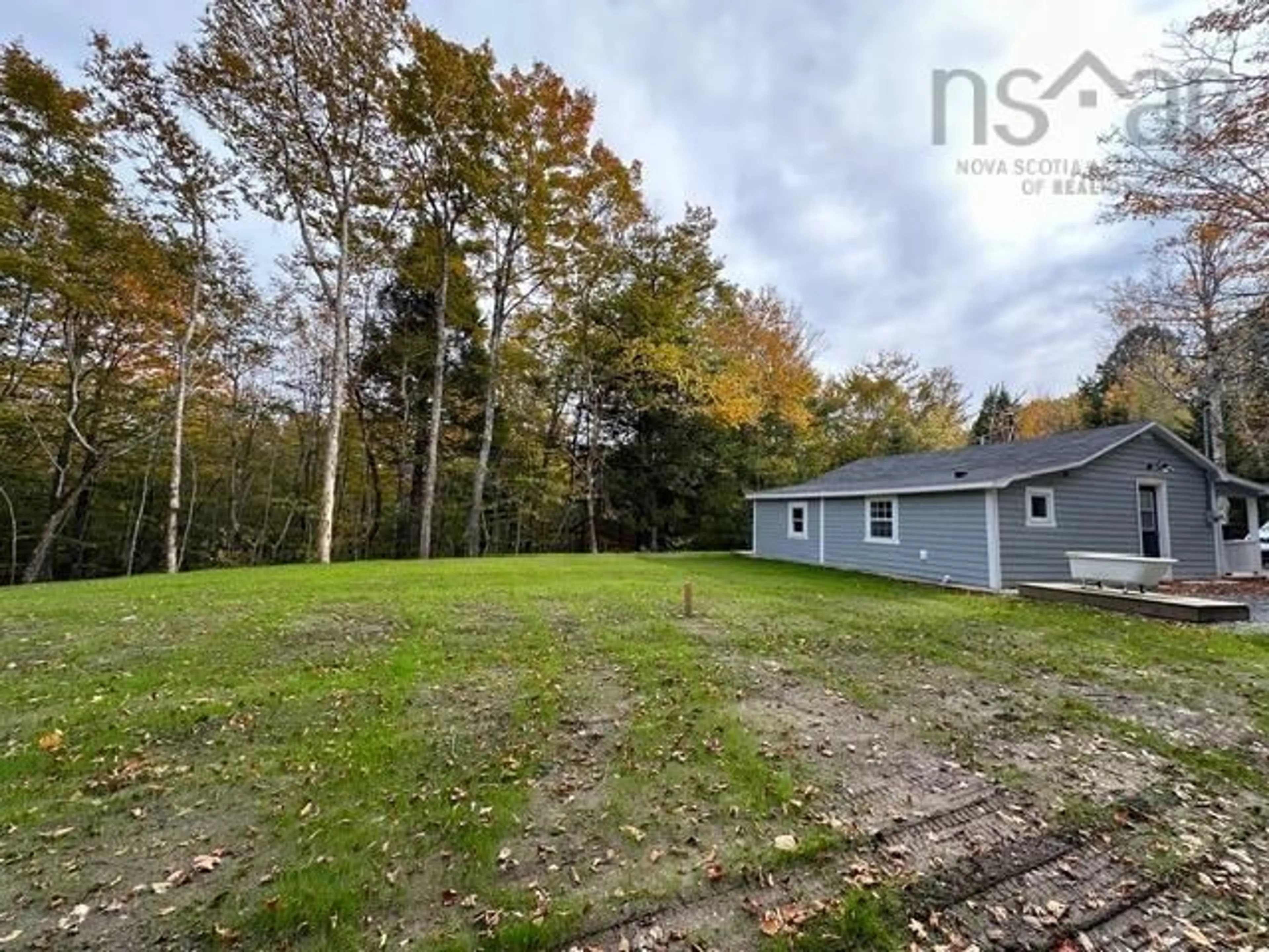 Frontside or backside of a home, the fenced backyard for 21 Woodland Ave, Conquerall Mills Nova Scotia B4V 6G7