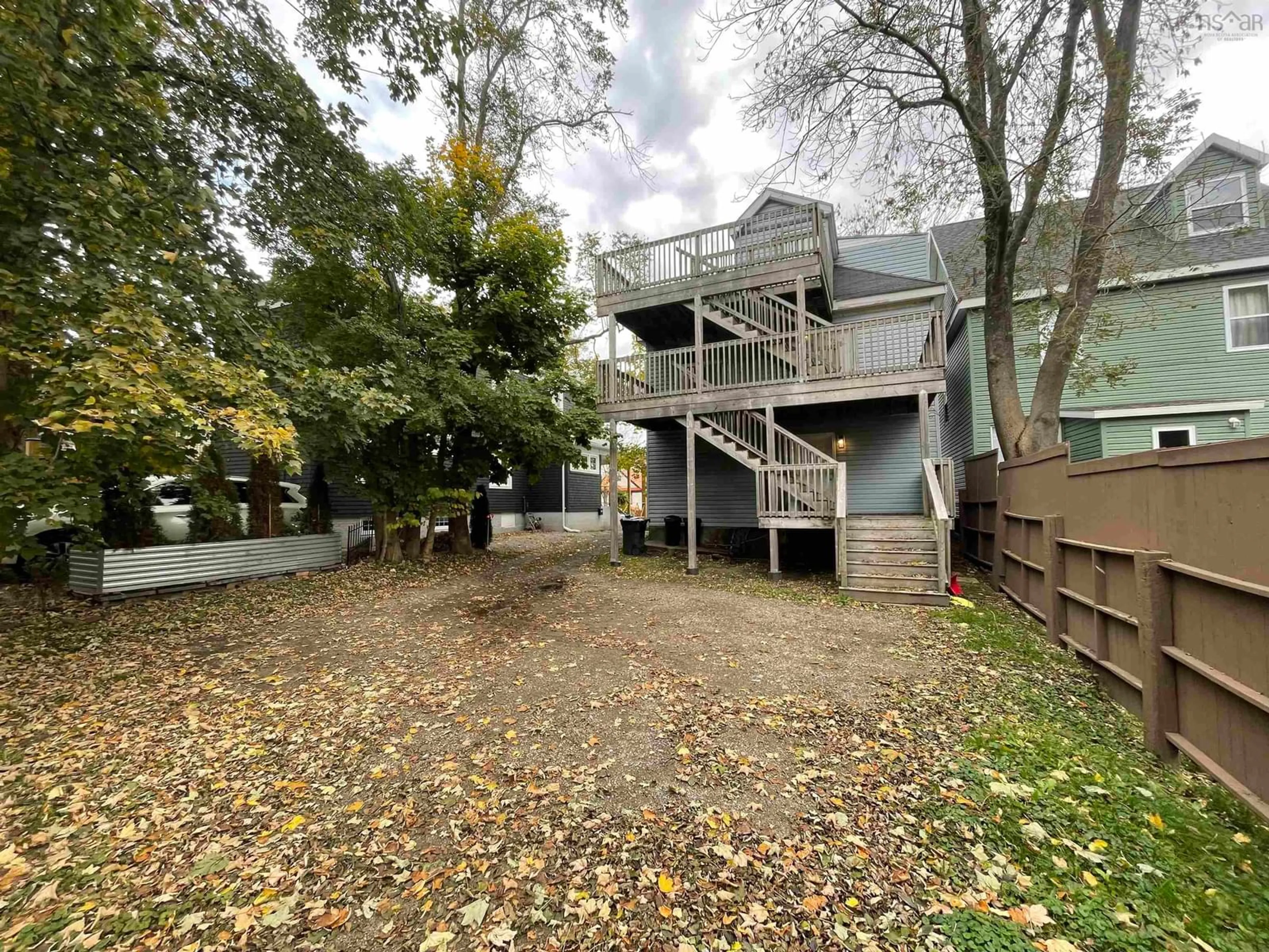 A pic from exterior of the house or condo, the fenced backyard for 92 George St, Sydney Nova Scotia B1P 1H7