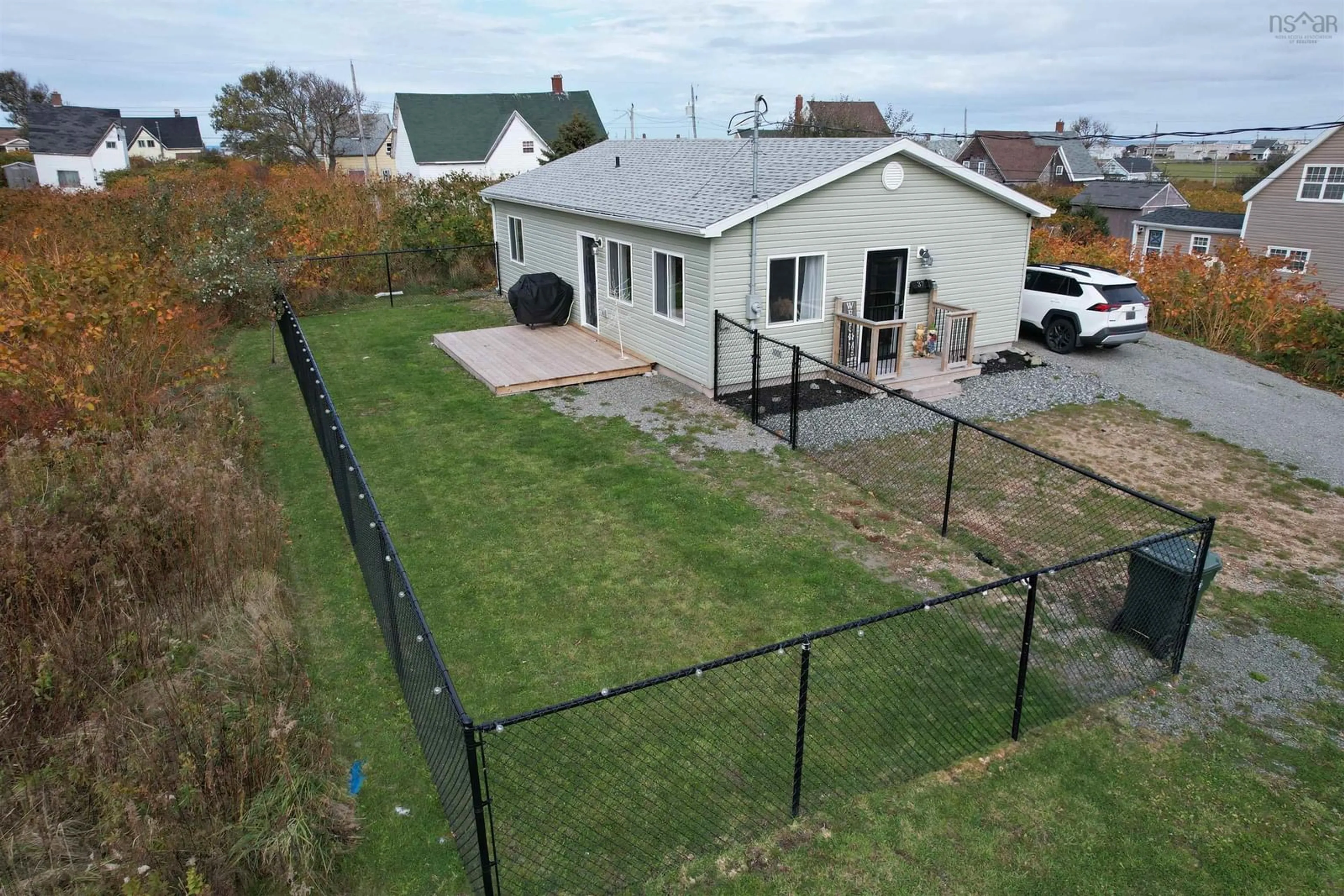 Frontside or backside of a home, the fenced backyard for 37 Second St, Glace Bay Nova Scotia B1A 4E7