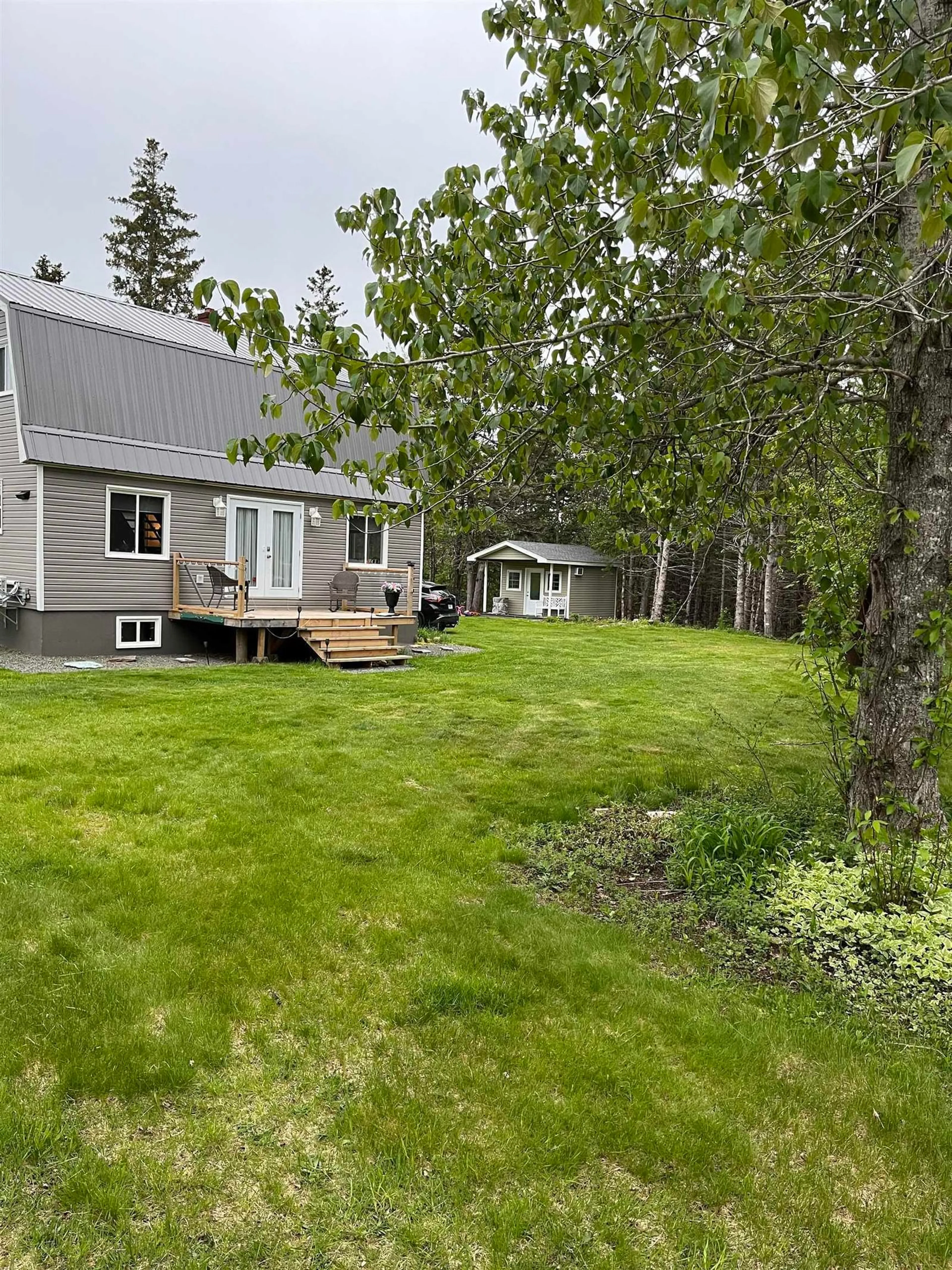 A pic from exterior of the house or condo, the fenced backyard for 2302 Cabot Trail, Middle River Nova Scotia B0E 1B0