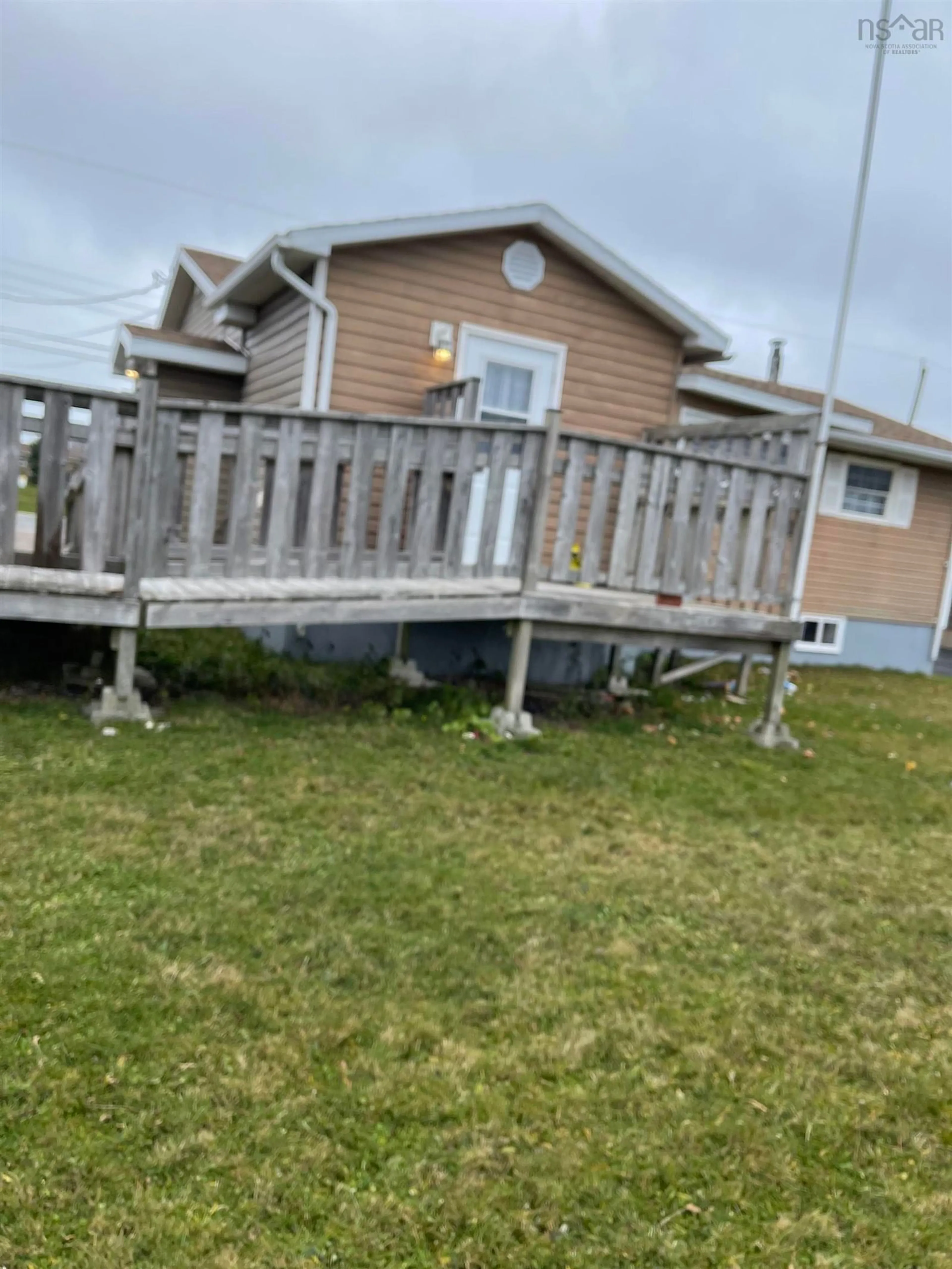 Frontside or backside of a home, the fenced backyard for 4 Oram St, Sydney Mines Nova Scotia B1V 2Z2