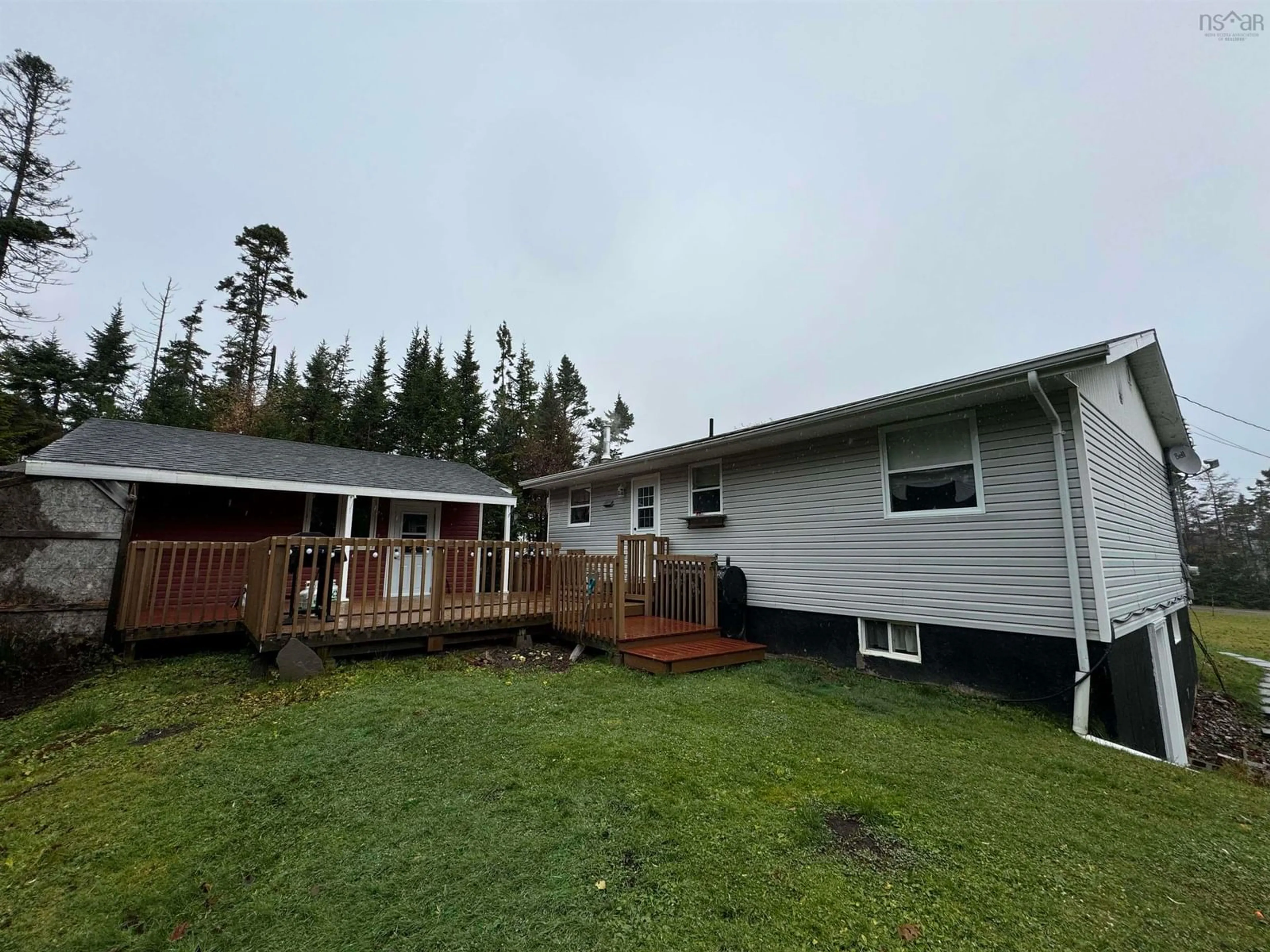 Frontside or backside of a home, the fenced backyard for 77 De Raymond St, St. Peter's Nova Scotia B0E 3B0