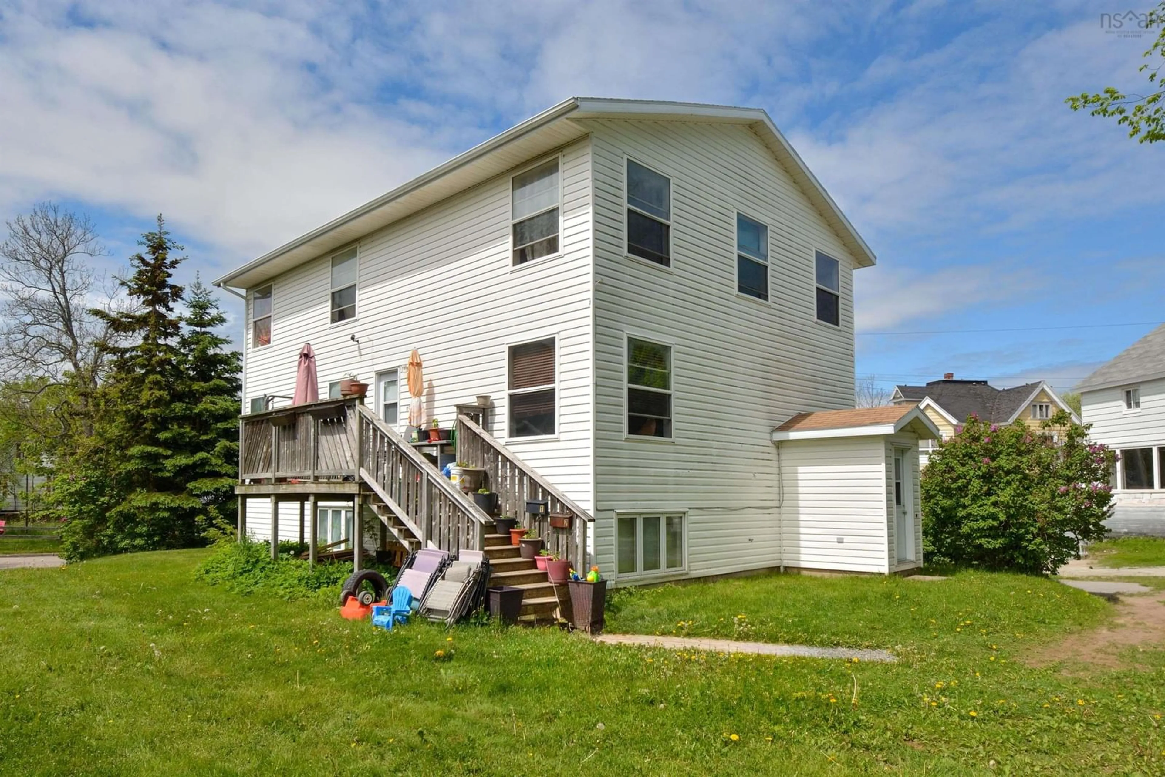 Frontside or backside of a home, the fenced backyard for 191 Inglis St, Sydney Nova Scotia B1P 1X1