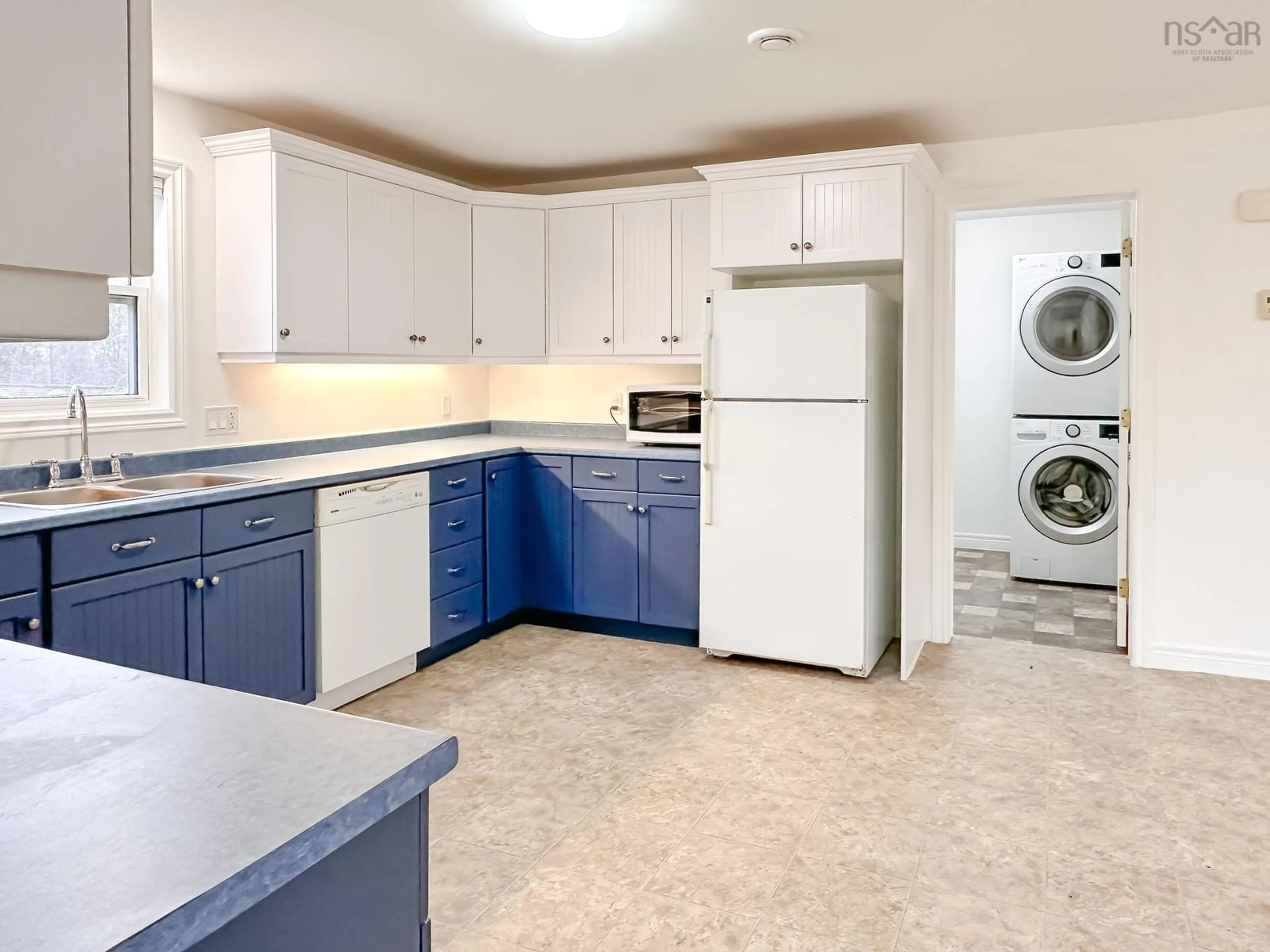 Kitchen with laundary machines, cement floor for 1600 South Bishop Rd, Coldbrook Nova Scotia B4R 1A7