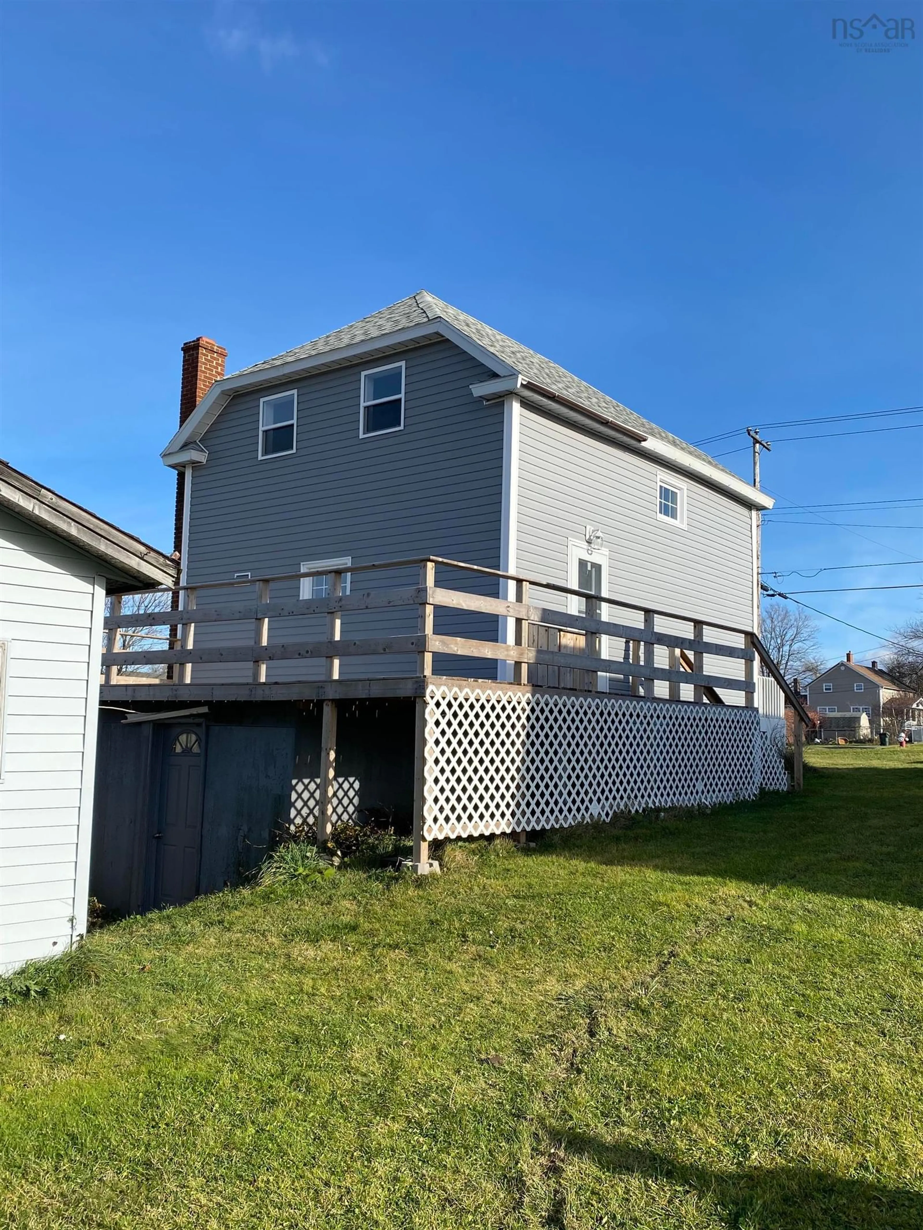 Frontside or backside of a home, the fenced backyard for 583 Heelan St, New Waterford Nova Scotia B1H 3C6