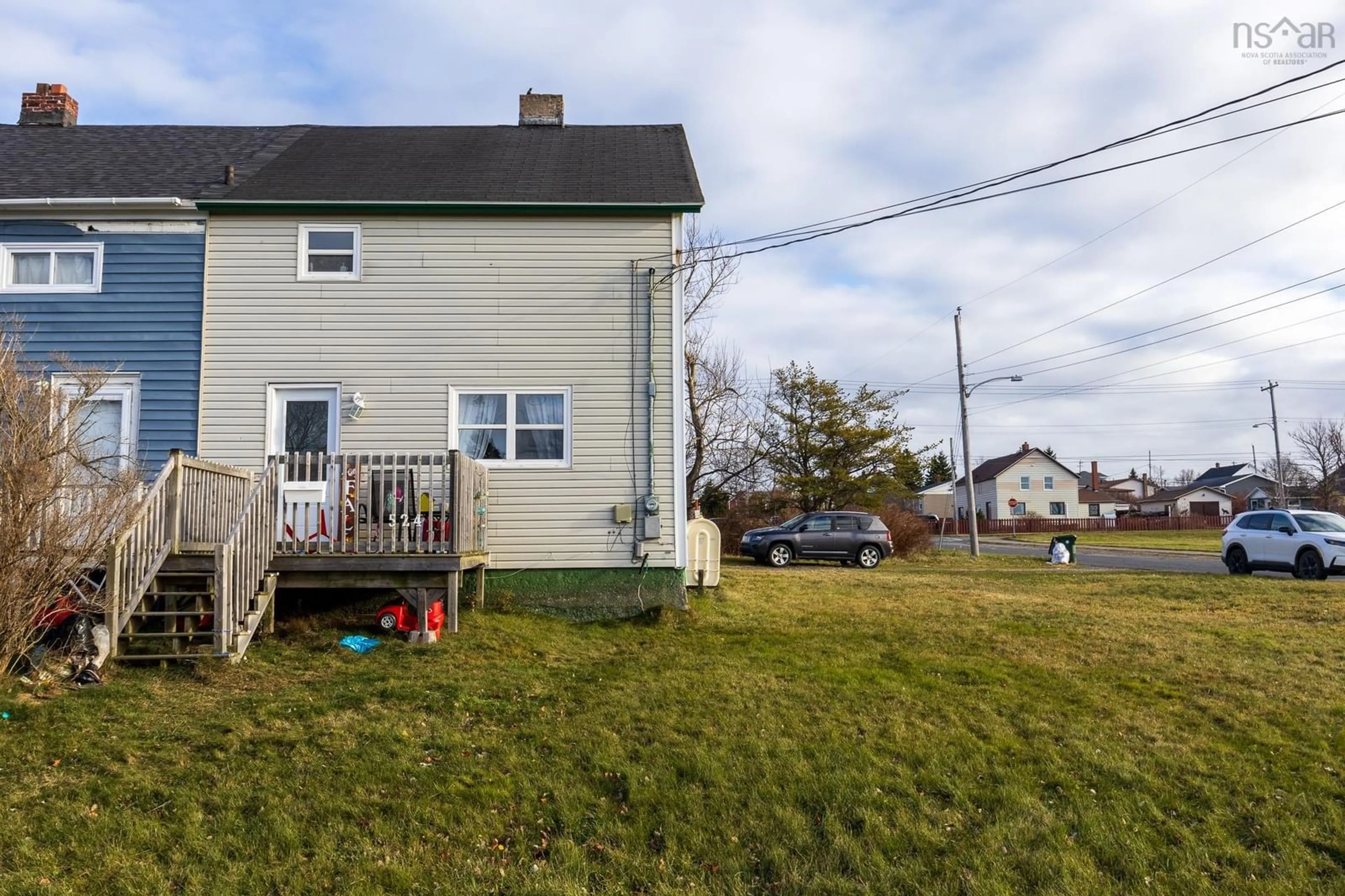 Frontside or backside of a home, the fenced backyard for 524 Second Street, New Waterford Nova Scotia B1H 3A6