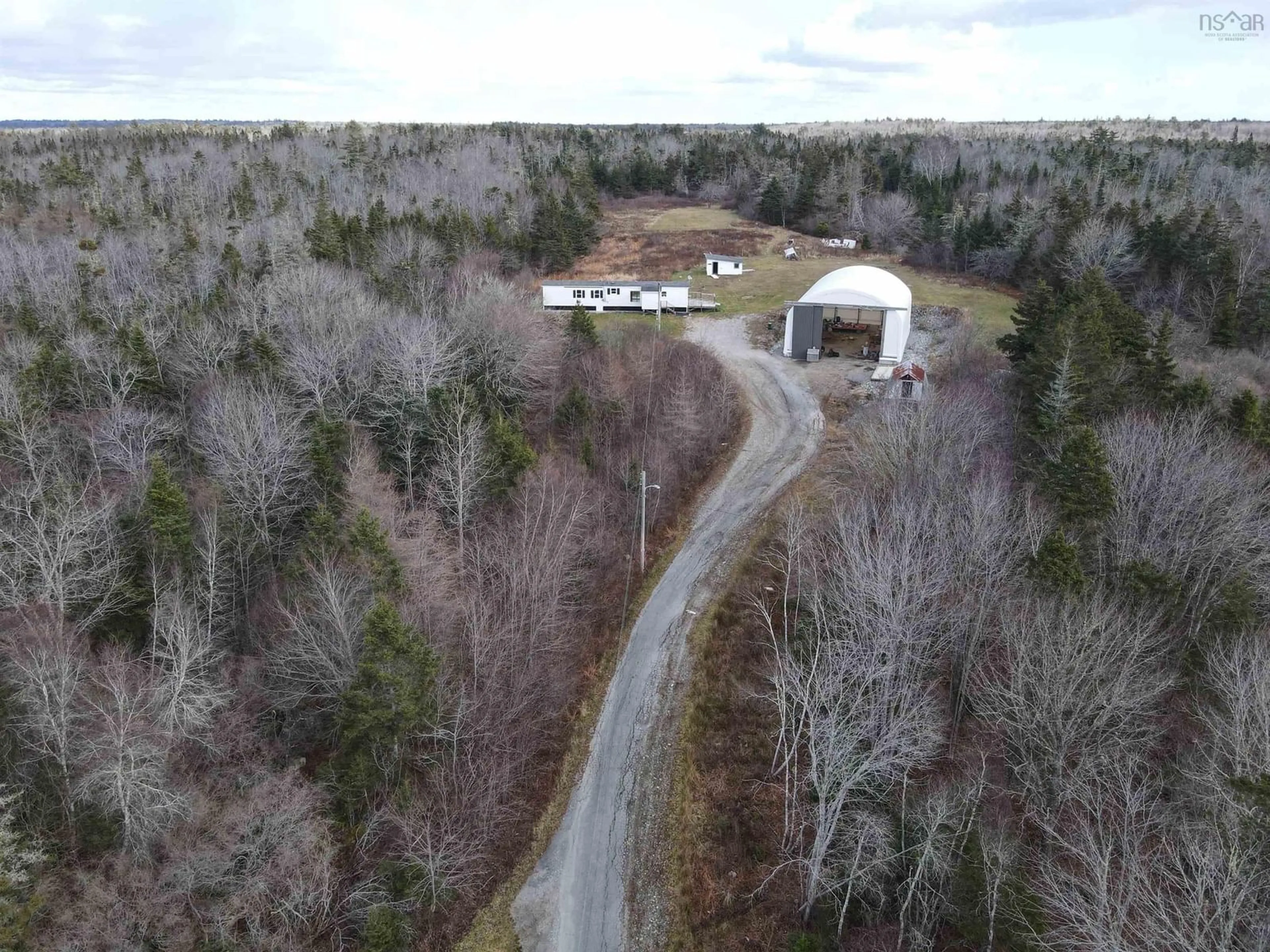 A pic from outside/outdoor area/front of a property/back of a property/a pic from drone, forest/trees view for 1863 Sandy Point Rd, Sandy Point Nova Scotia B0T 1W0