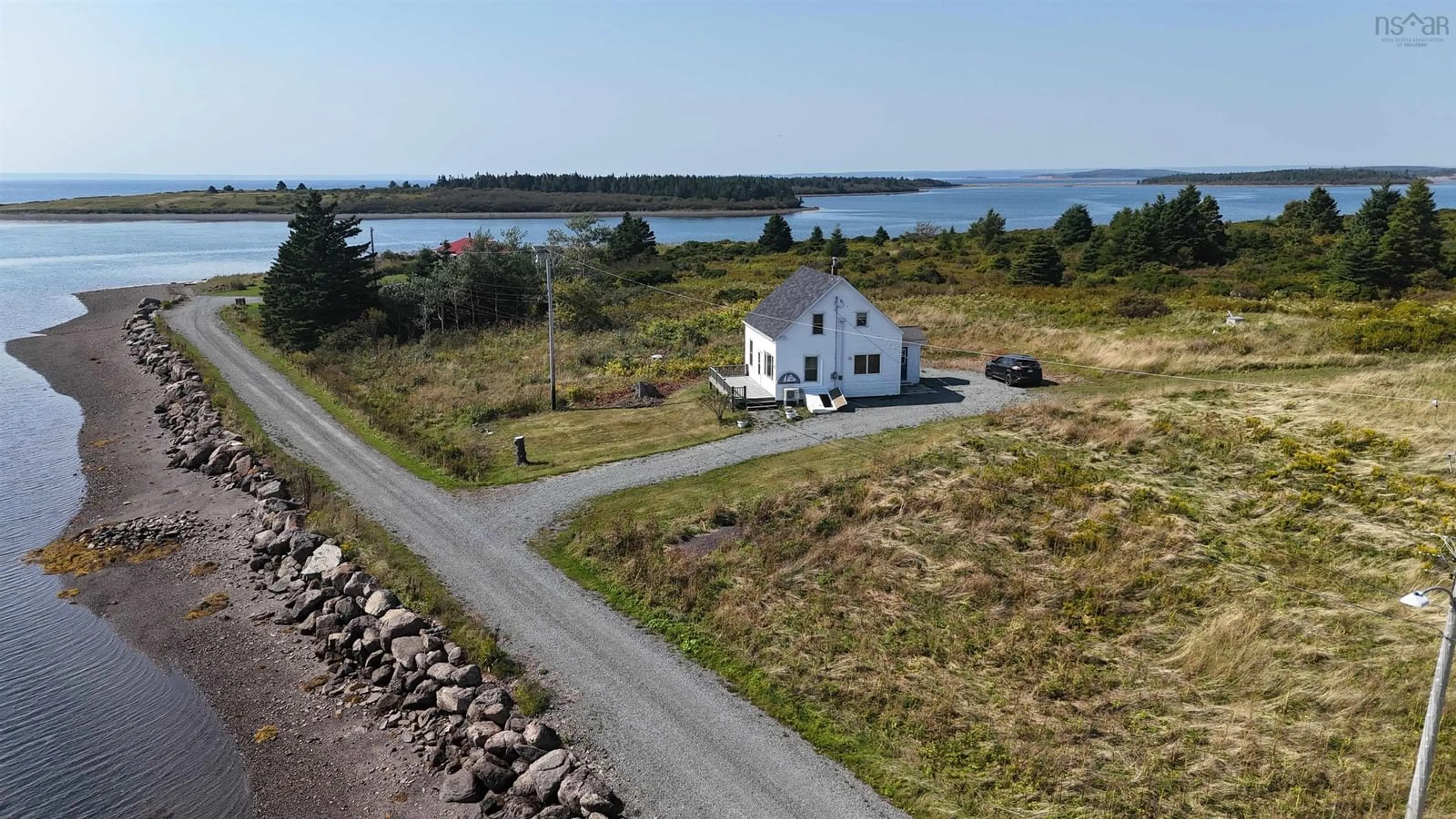 A pic from outside/outdoor area/front of a property/back of a property/a pic from drone, water/lake/river/ocean view for 20 Meunier Lane, West Arichat Nova Scotia B0E 3J0