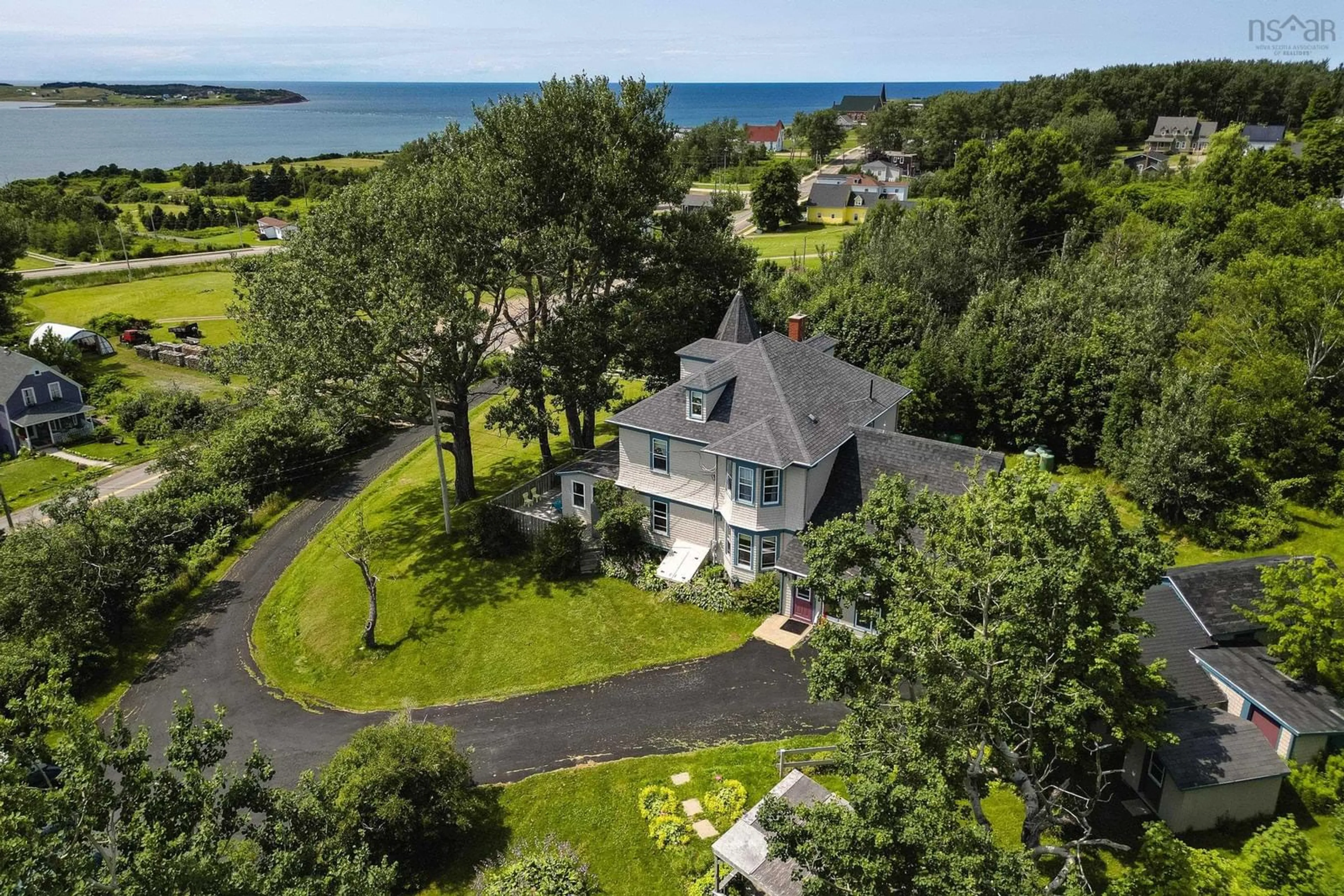 A pic from outside/outdoor area/front of a property/back of a property/a pic from drone, water/lake/river/ocean view for 55 High Rd, Port Hood Nova Scotia B0E 2W0