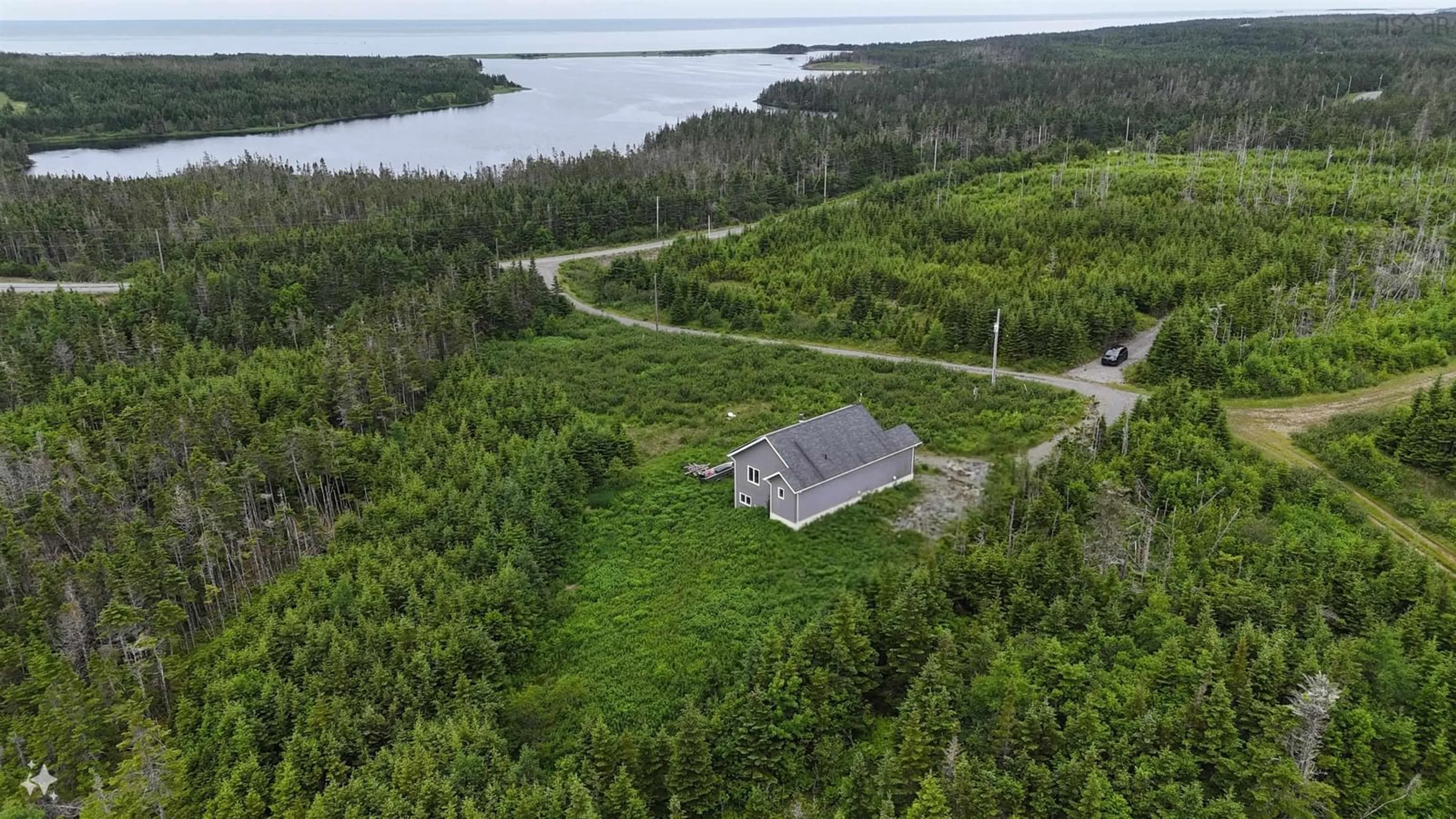 A pic from outside/outdoor area/front of a property/back of a property/a pic from drone, water/lake/river/ocean view for 4381 St. Peter's Fourchu Rd, Grand River Nova Scotia B0E 1M0