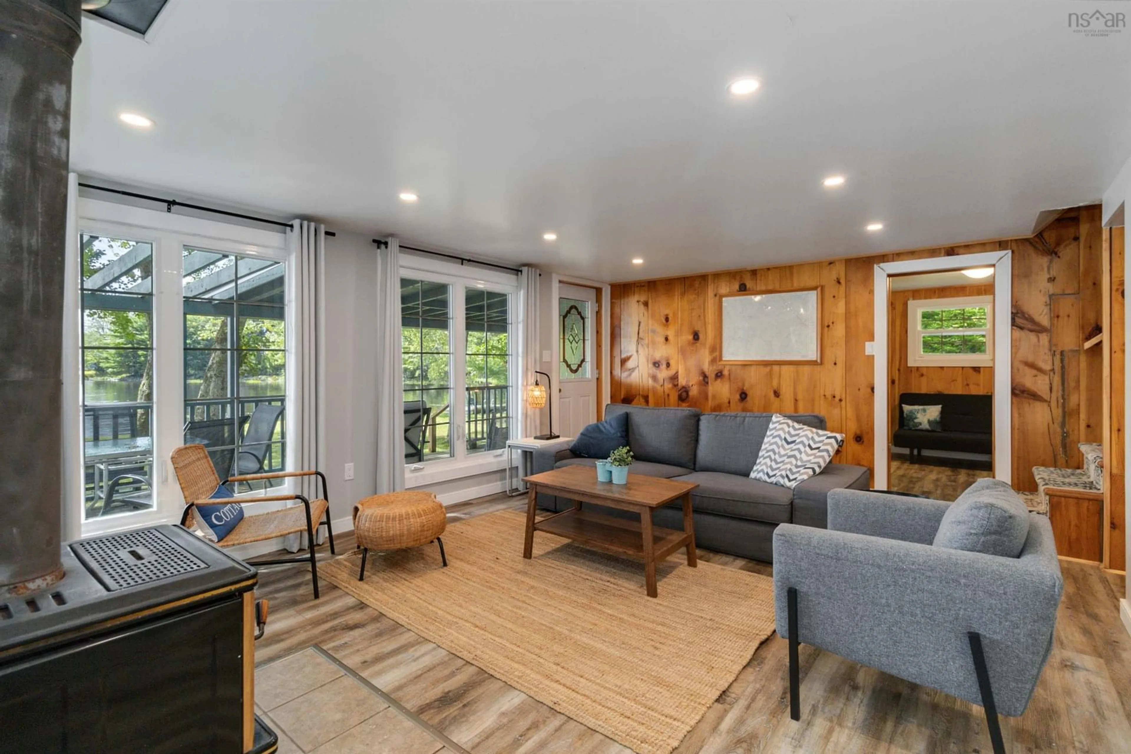 Living room with furniture, wood/laminate floor for 507 & 521 Keddy Cove Rd, Molega Lake Nova Scotia B4V 4W6