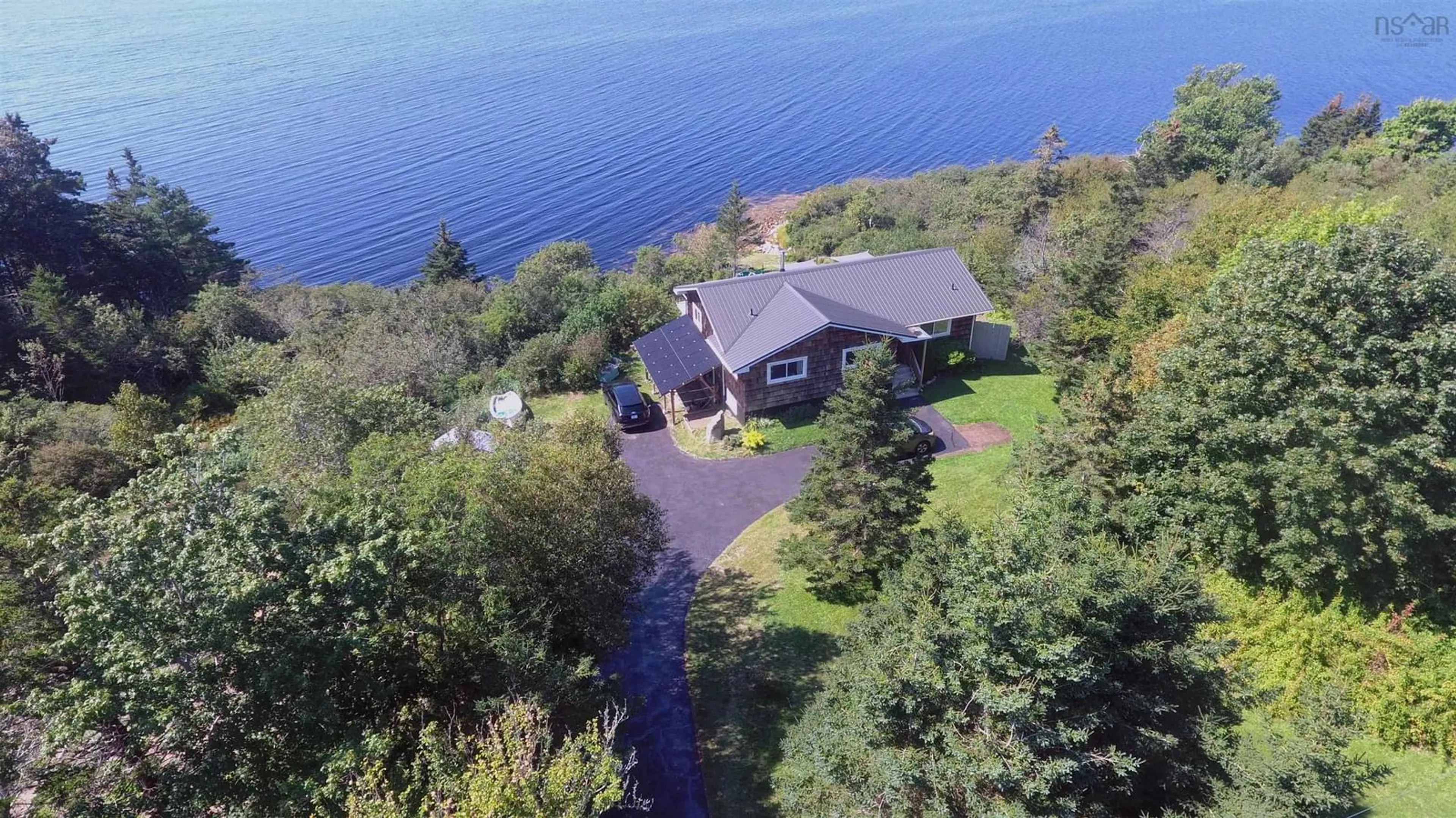 A pic from outside/outdoor area/front of a property/back of a property/a pic from drone, water/lake/river/ocean view for 1050 Sandy Point Rd, Sandy Point Nova Scotia B0T 1W0