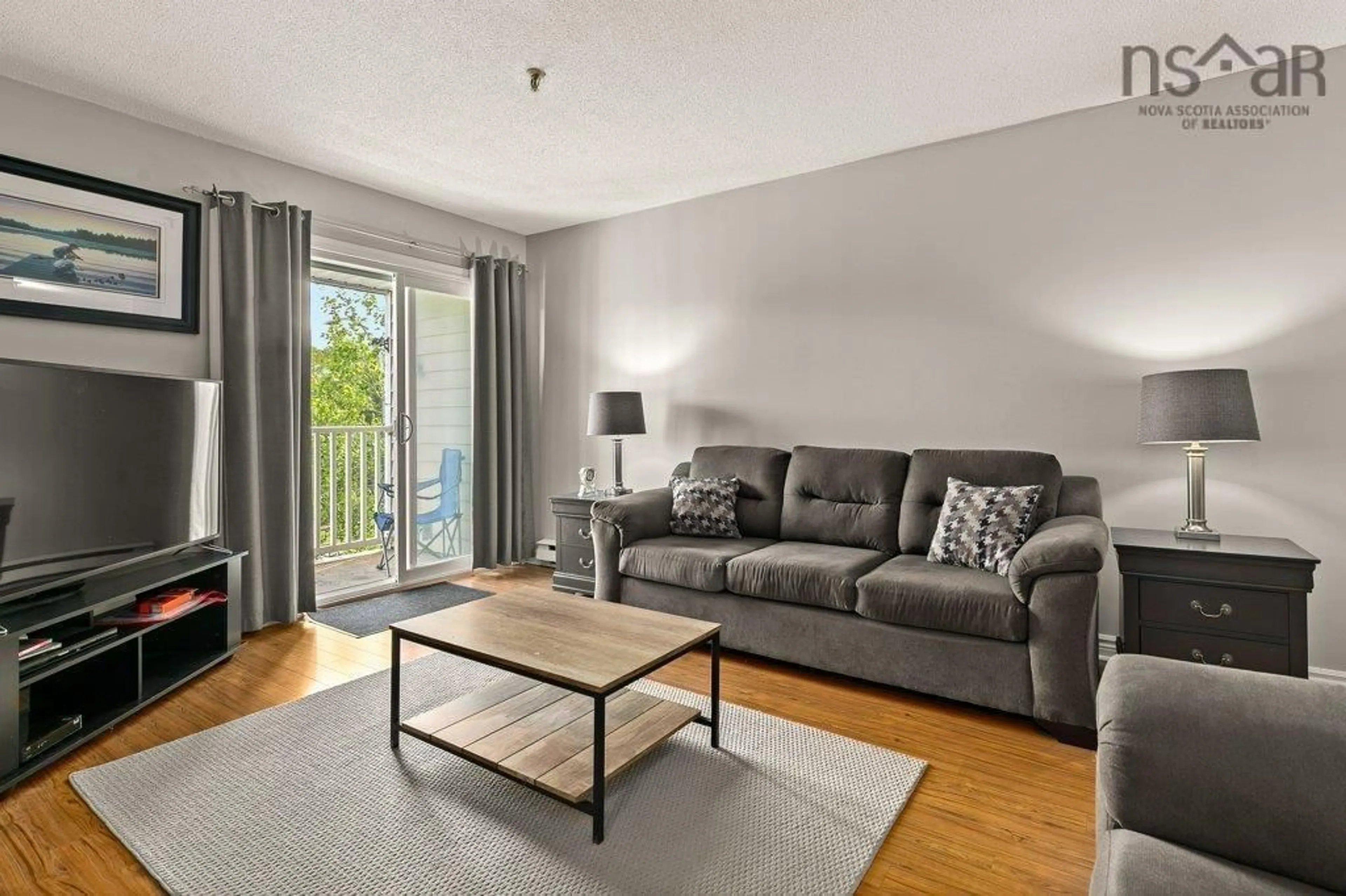 Living room with furniture, wood/laminate floor for 15 Langbrae Dr #203, Halifax Nova Scotia B3M 3W5