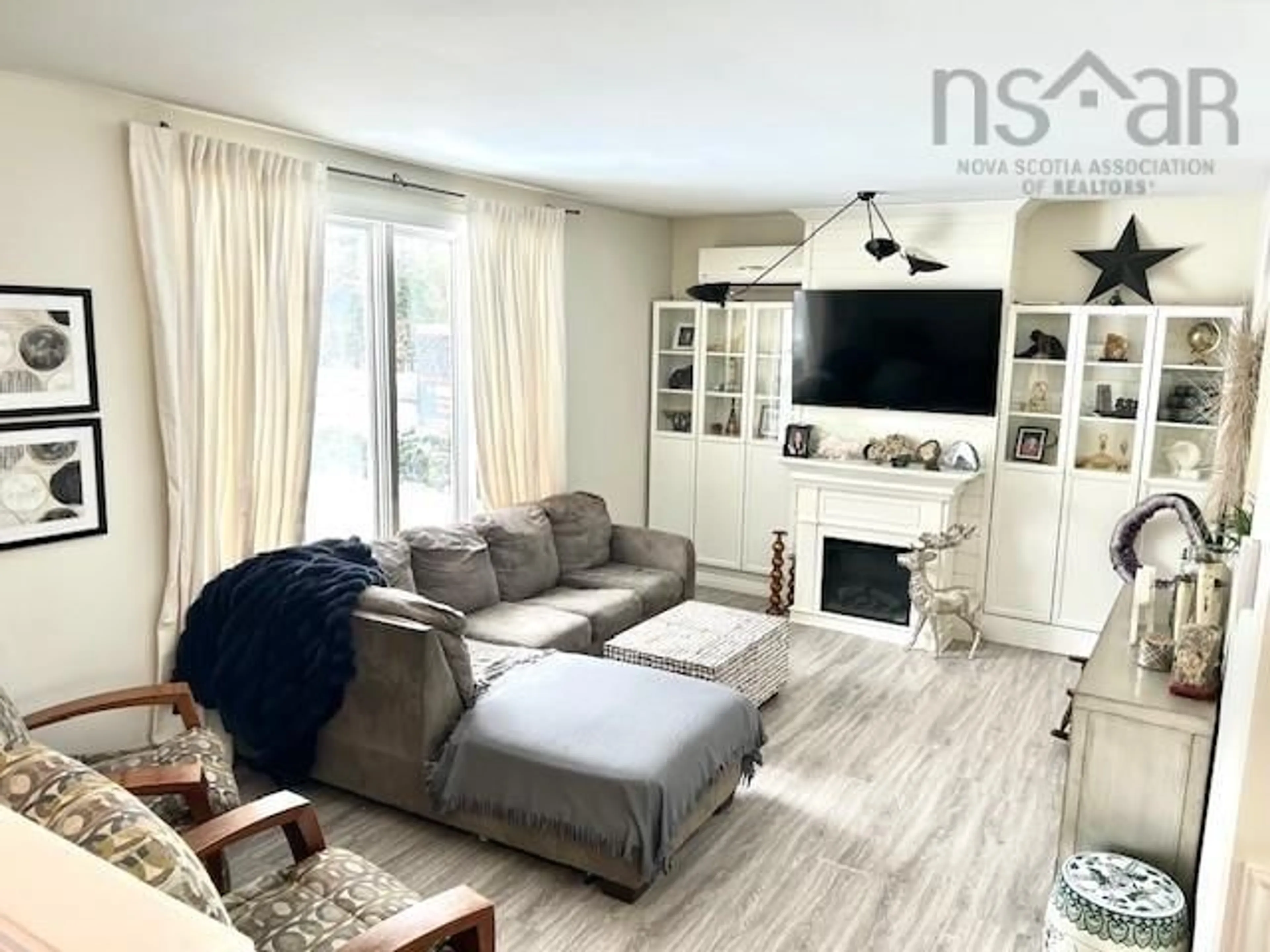 Living room with furniture, wood/laminate floor for 39 Falcon Rd, Valley Nova Scotia B6L 2G3