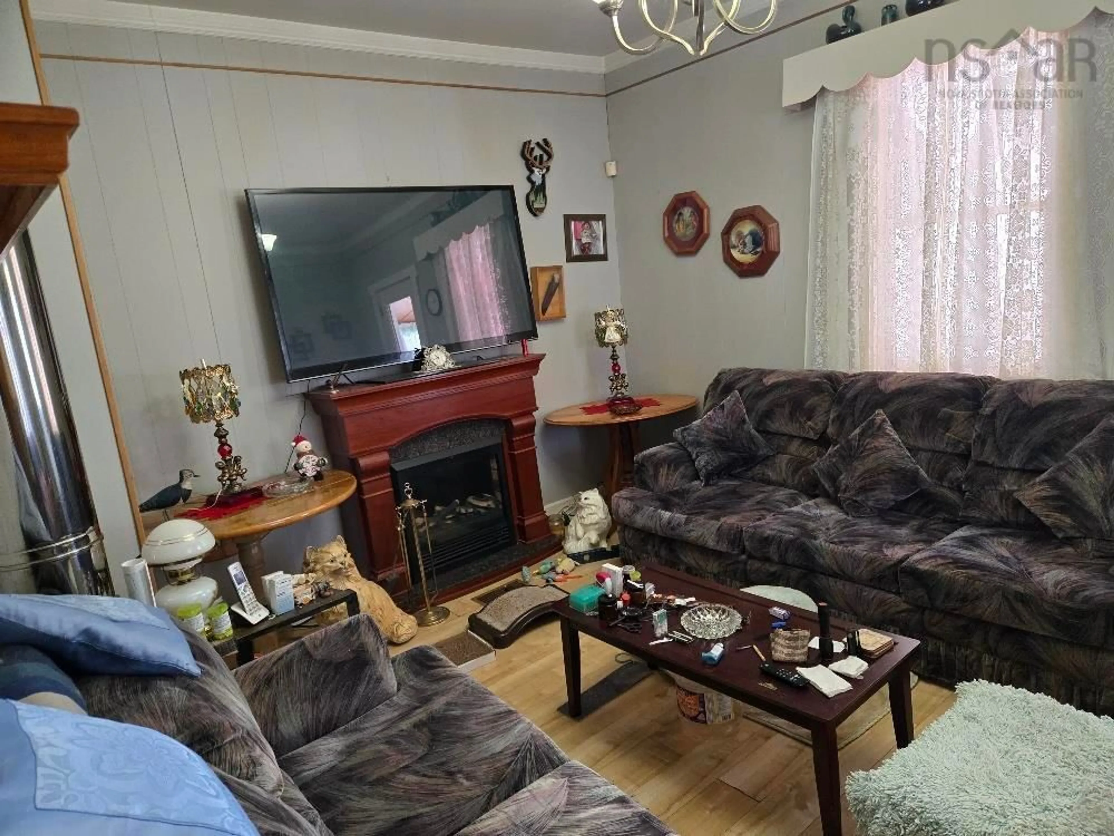 Living room with furniture, wood/laminate floor for 675 Mines Bass River Rd, Bass River Nova Scotia B0M 1B0