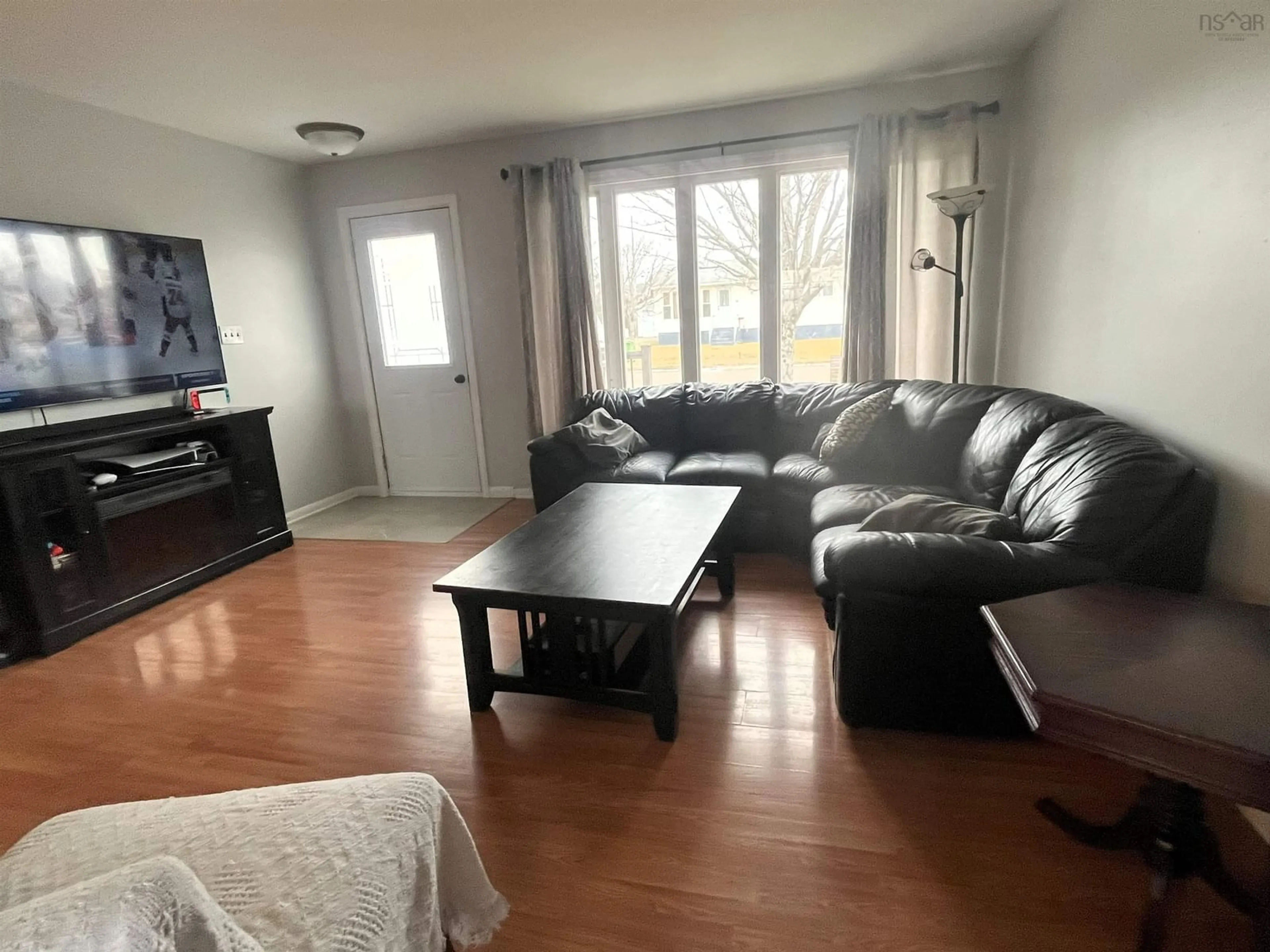 Living room with furniture, wood/laminate floor for 9 Harold St, Port Hawkesbury Nova Scotia B9A 2Z8