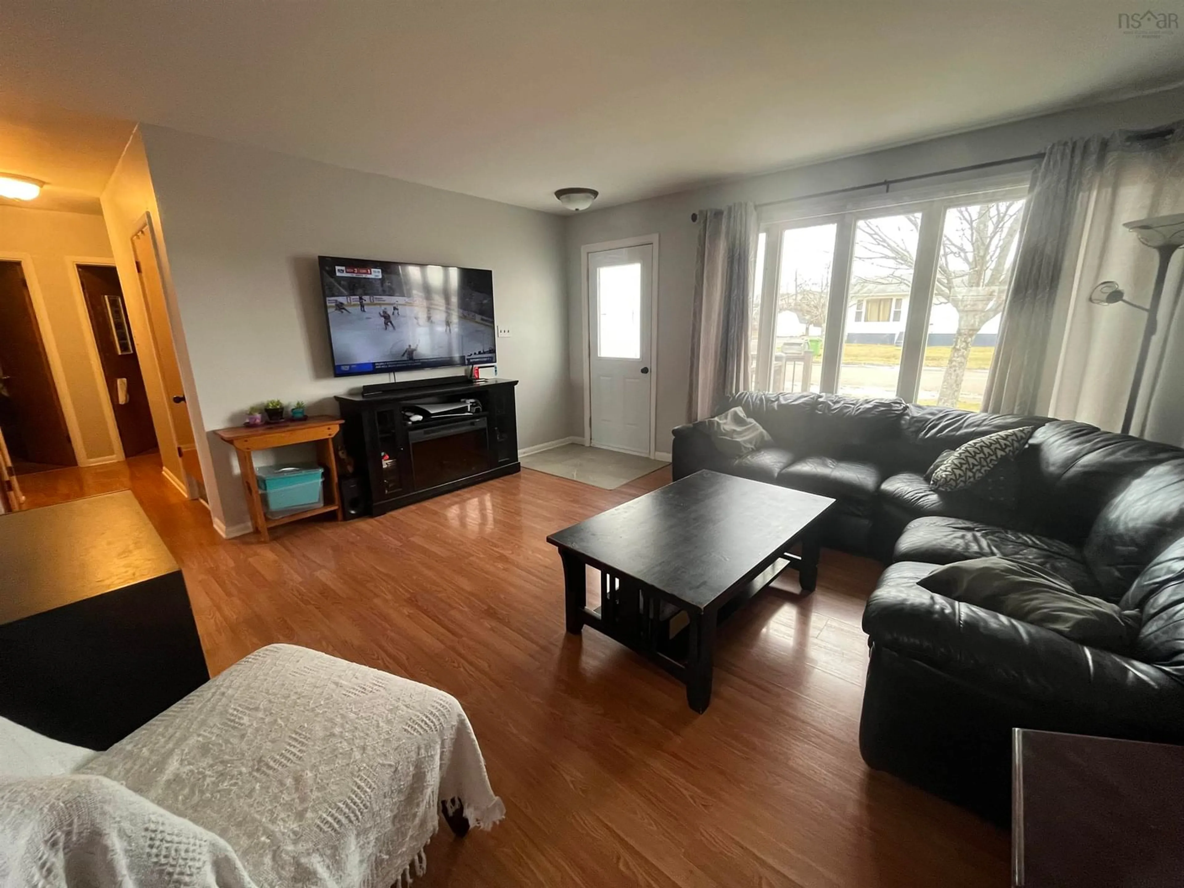 Living room with furniture, wood/laminate floor for 9 Harold St, Port Hawkesbury Nova Scotia B9A 2Z8