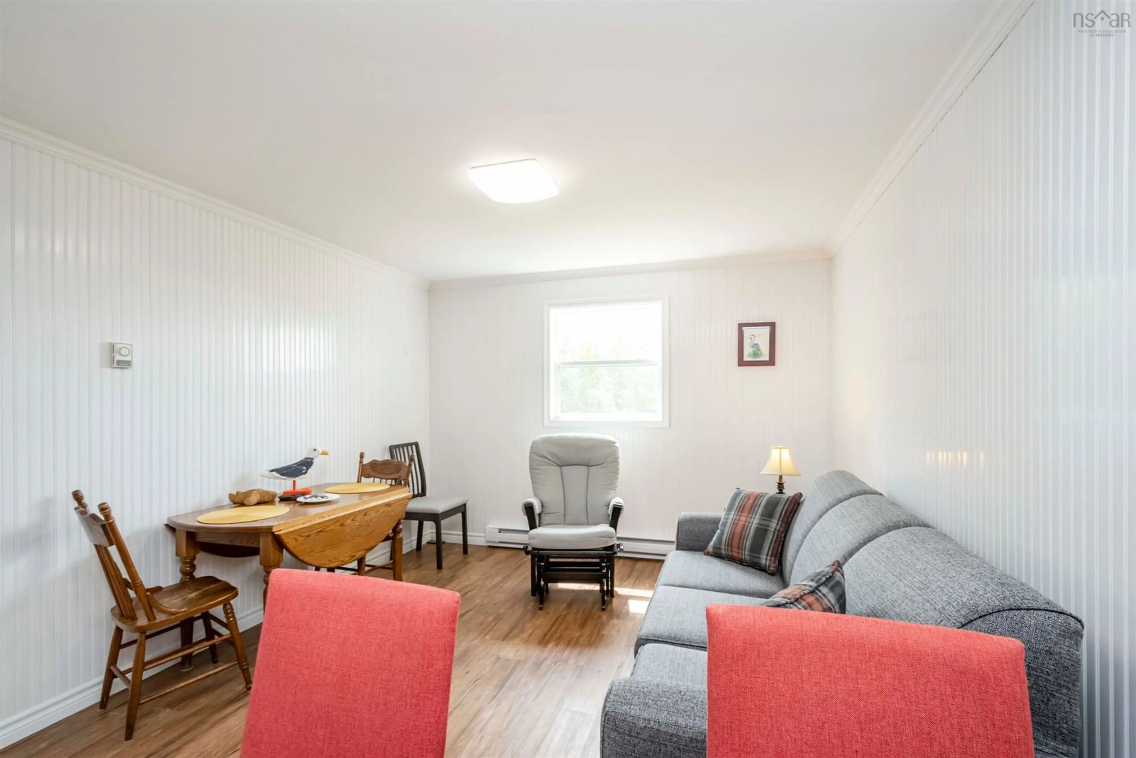 Living room with furniture, wood/laminate floor for 3654 Shore Rd, Ponds Nova Scotia B0K 1G0