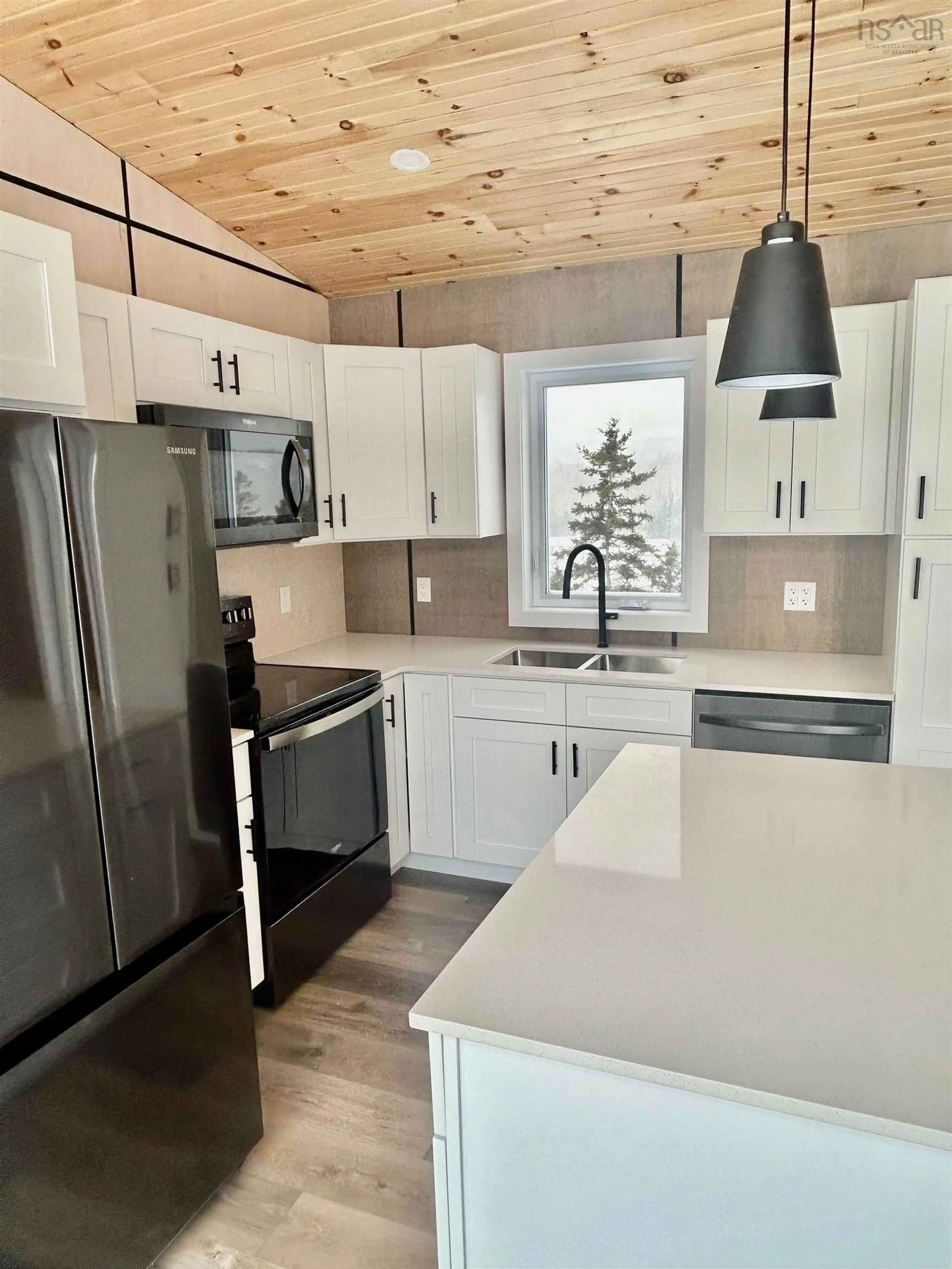 Open concept kitchen, wood/laminate floor for 25 Parkdale Cres, Inverness Nova Scotia B0E 1N0