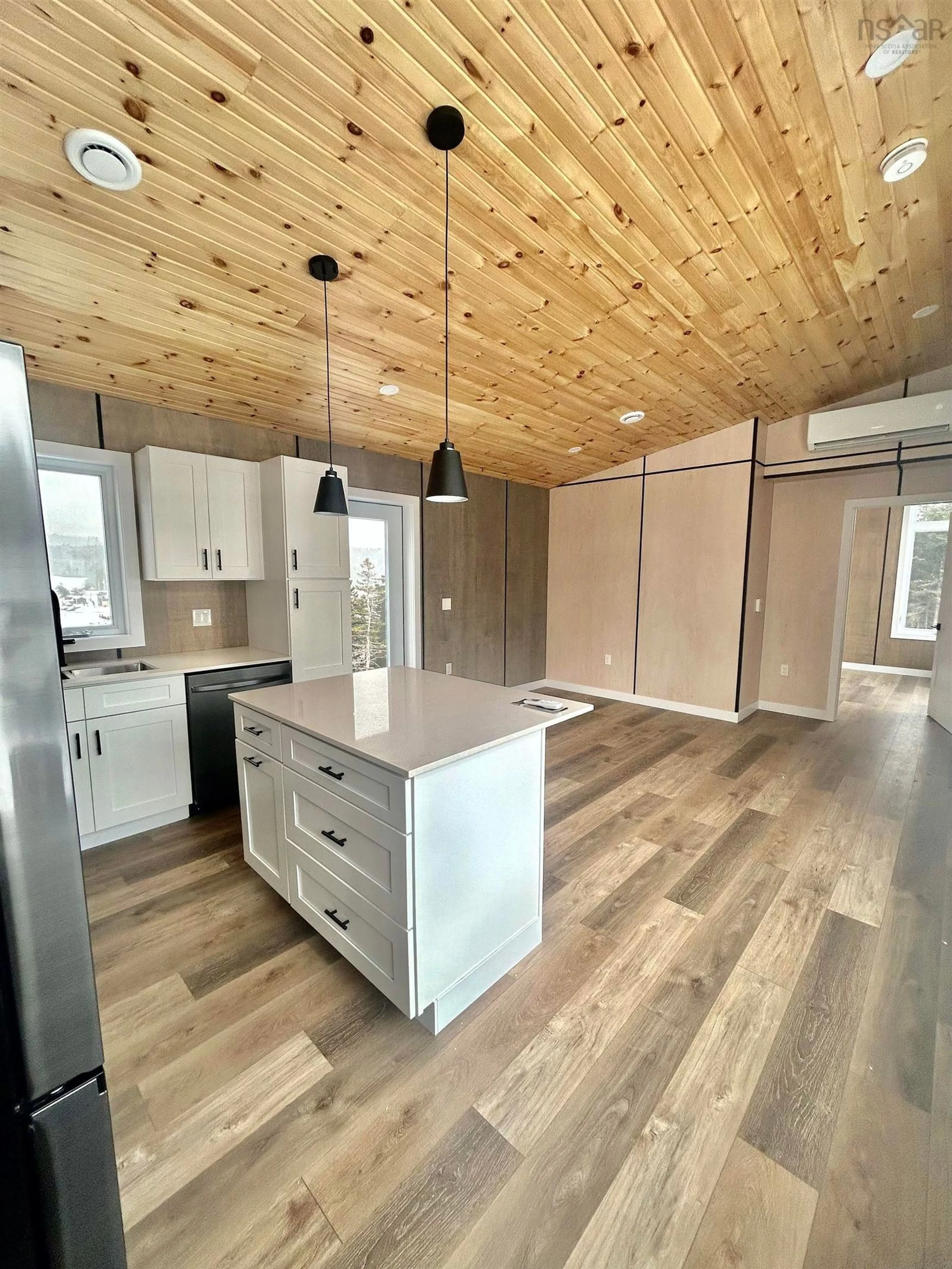 Open concept kitchen, wood/laminate floor for 25 Parkdale Cres, Inverness Nova Scotia B0E 1N0