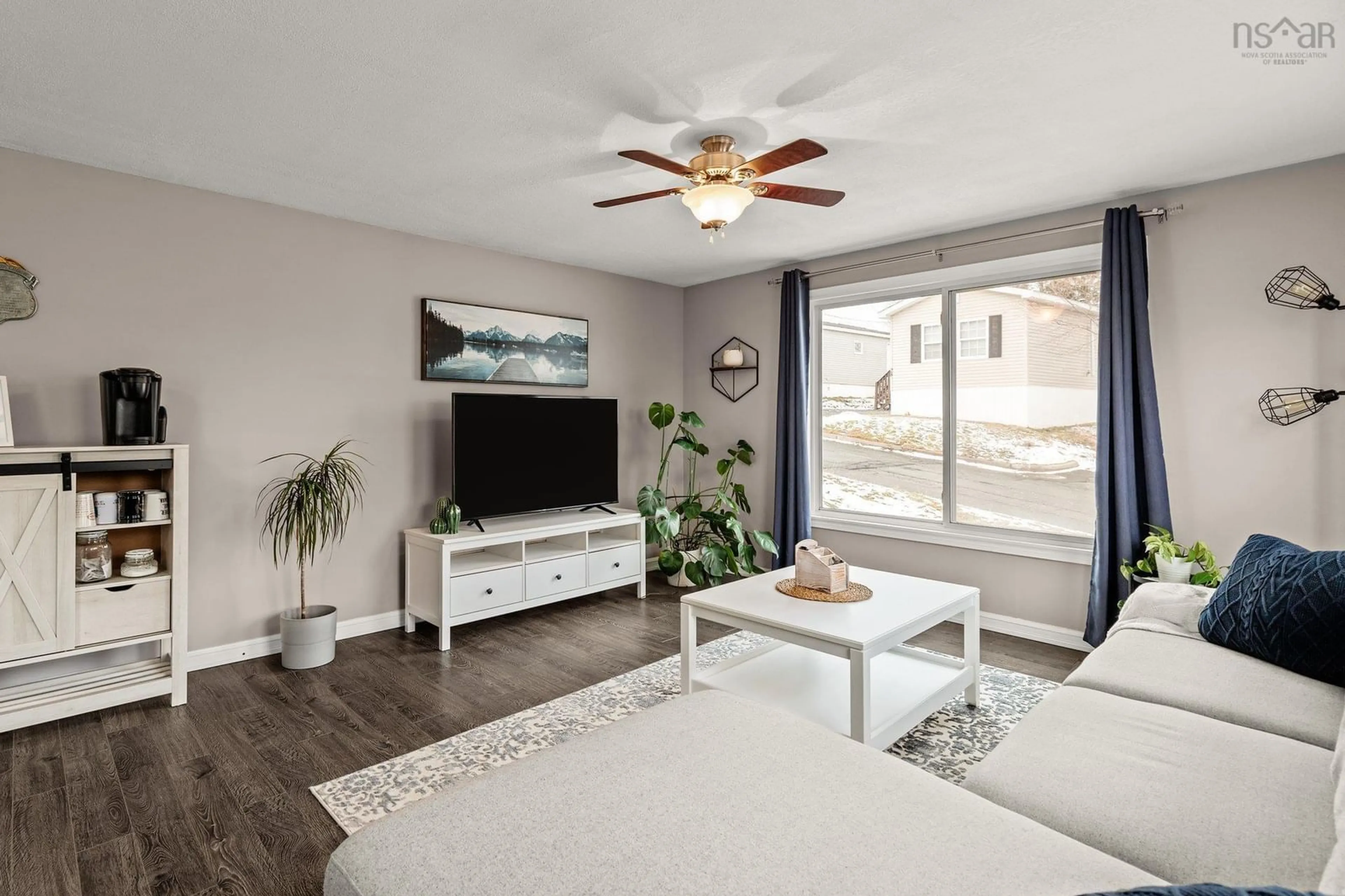 Living room with furniture, wood/laminate floor for 33 Stanley St, Middle Sackville Nova Scotia B4E 1E7