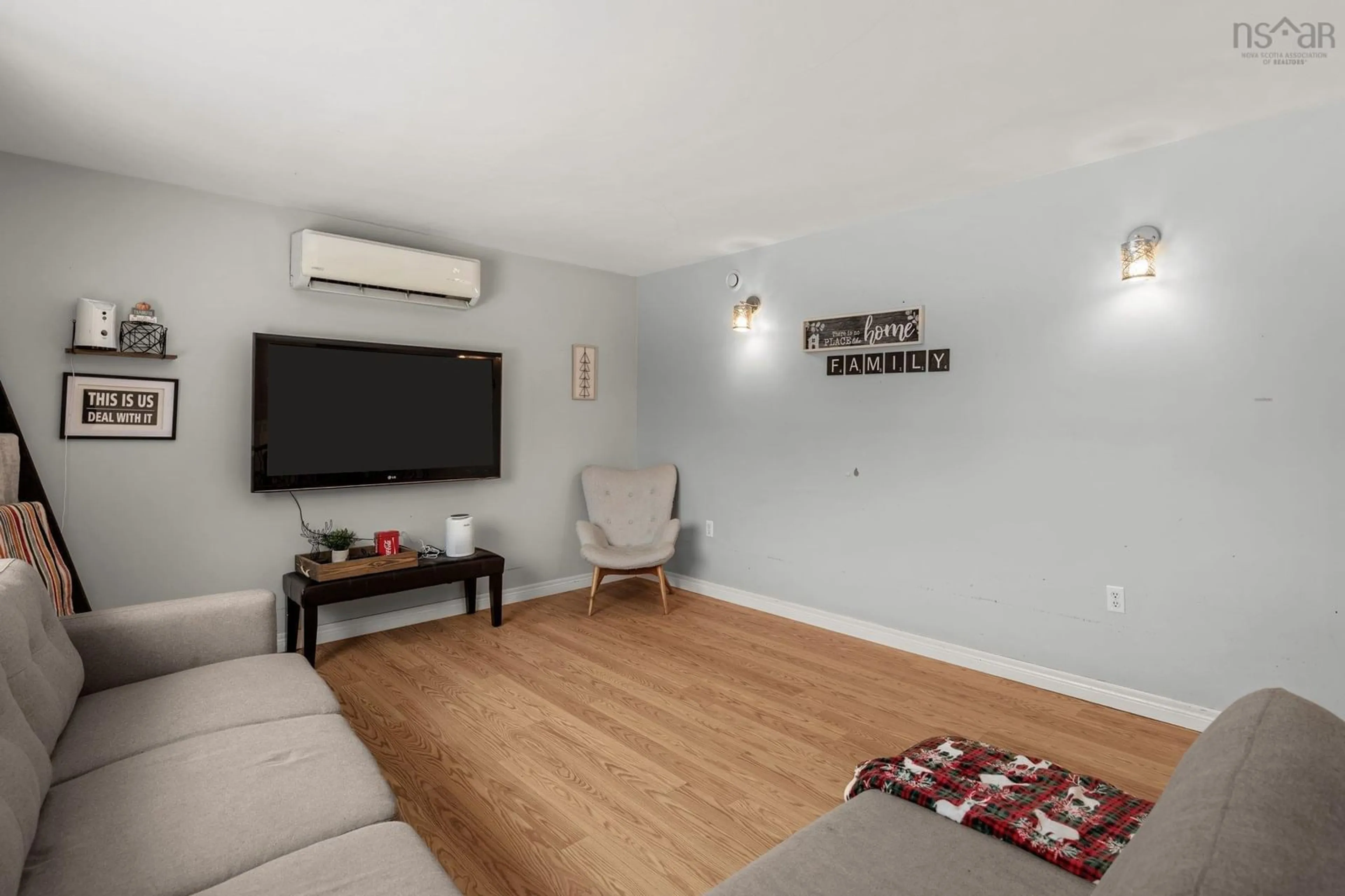 Living room with furniture, wood/laminate floor for 4660 Prospect Rd, Bayside Nova Scotia B3Z 1L8